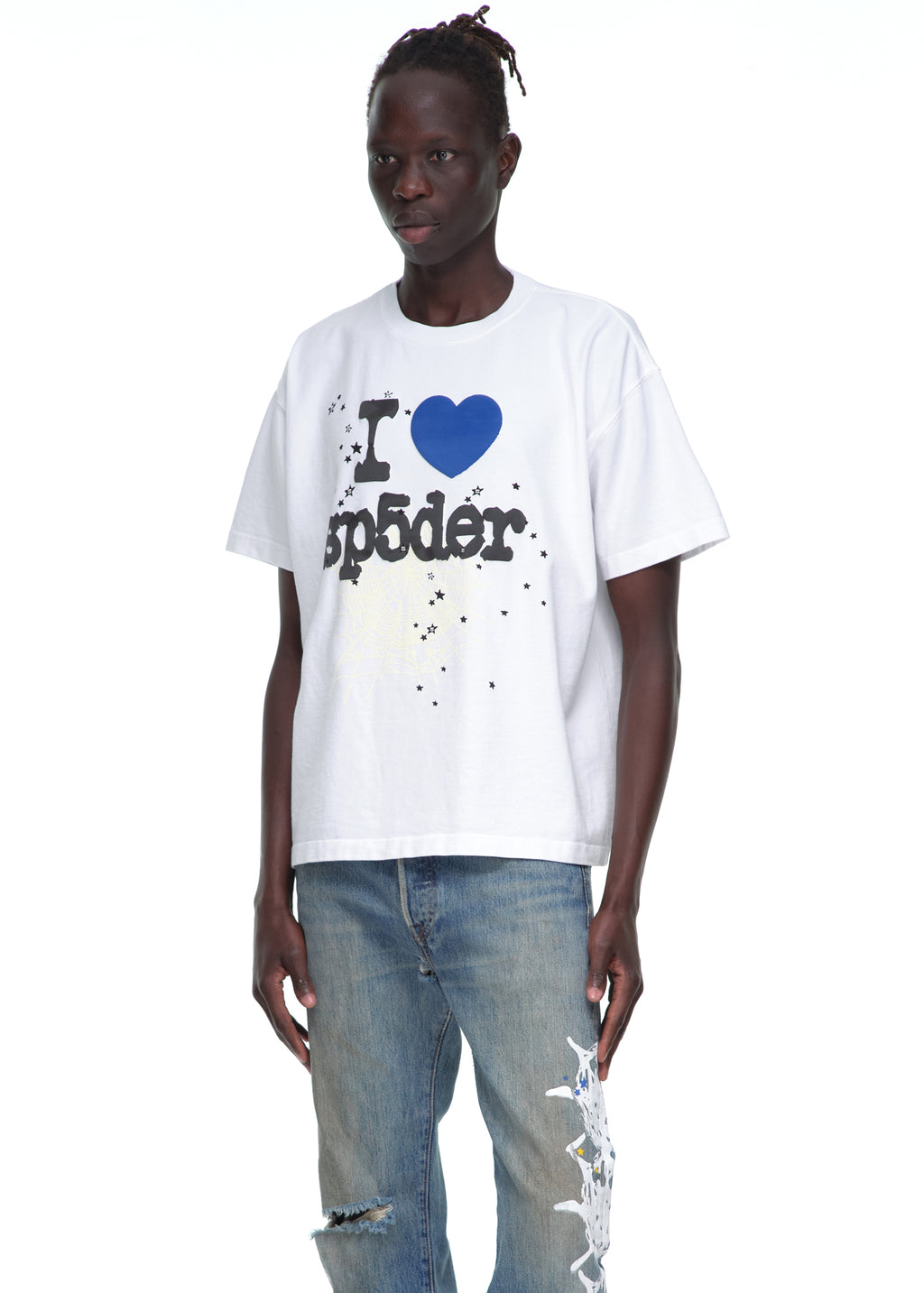 Male model wears a white 14oz cotton SOUVENIR TEE with "I ❤️ sp5der" graphic, paired with distressed jeans.