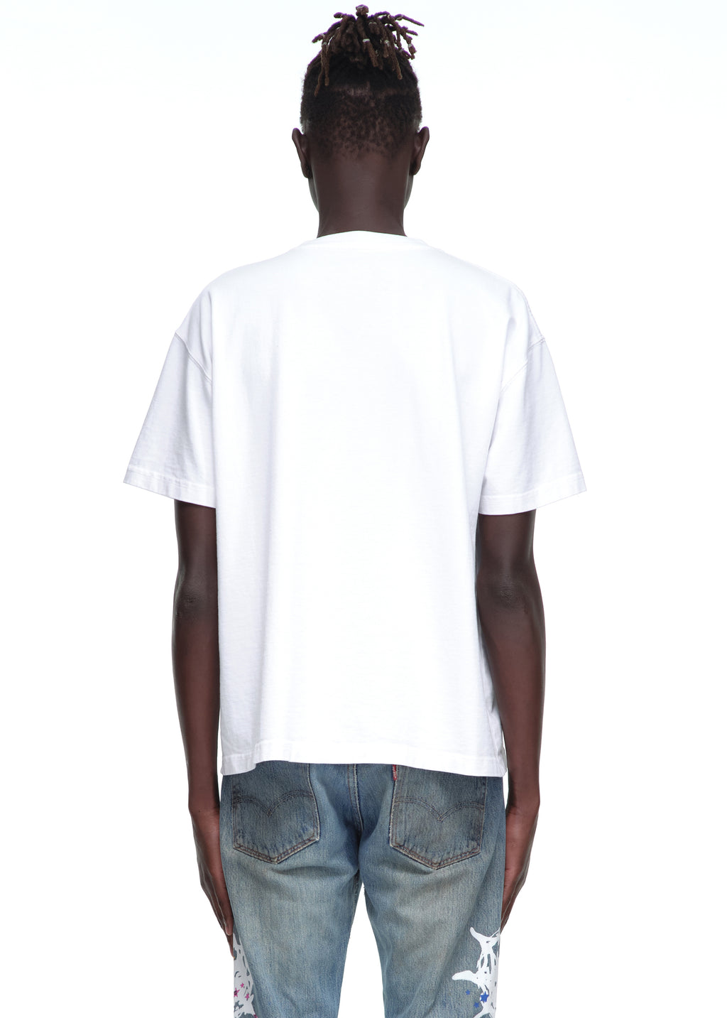 Back view of a male model wearing a plain white 14oz cotton Souvenir Tee with a standard fit.