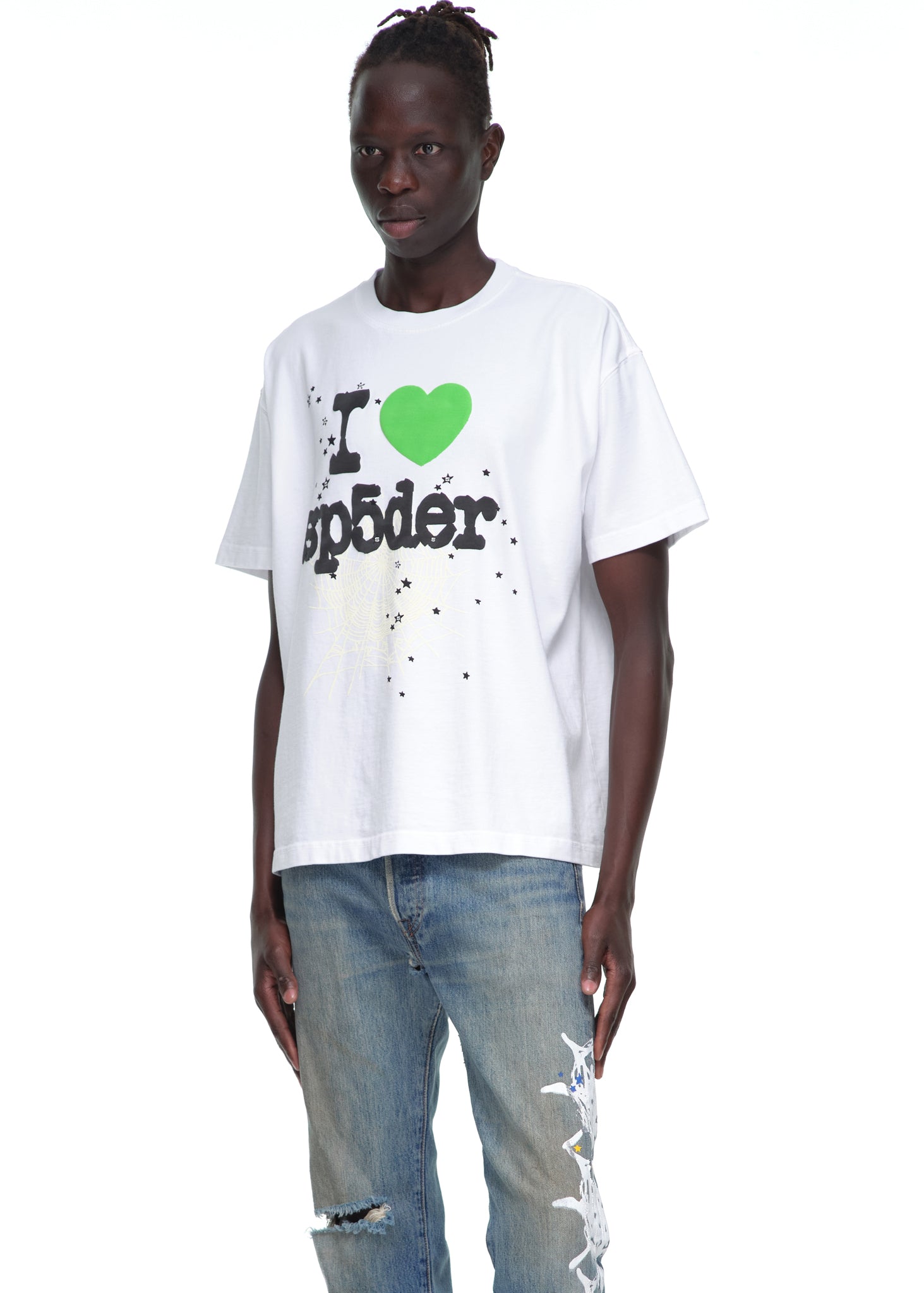 Male model in a white cotton "I love sp5der" graphic tee and distressed blue jeans.