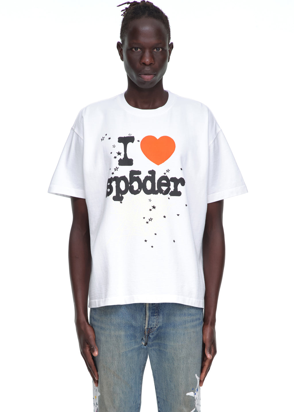 Male model in white 14oz cotton Souvenir Tee with "I ❤️ sp5der" graphic and stars, paired with jeans.