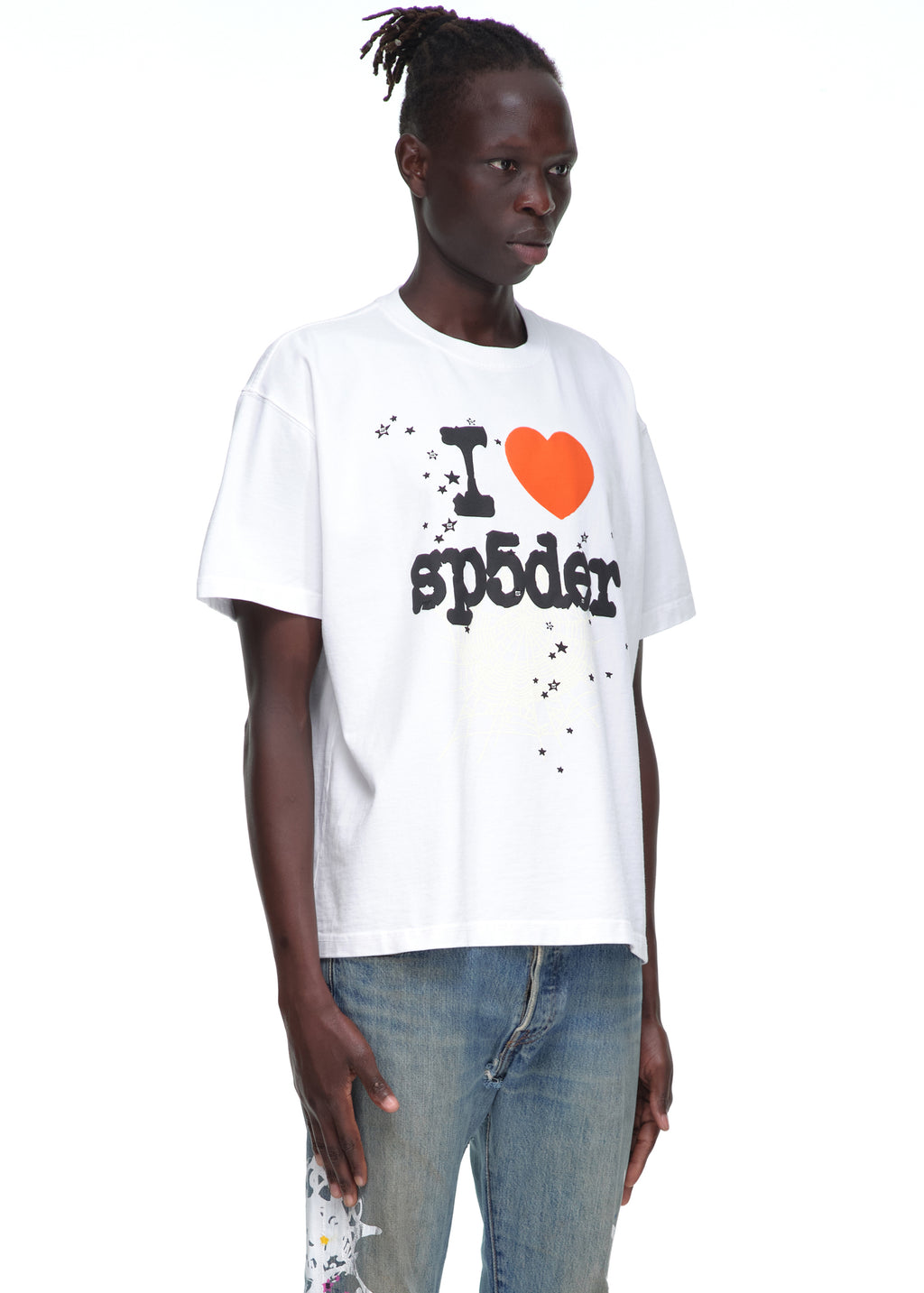 Male model in white 14oz cotton Souvenir Tee with "I ❤️ sp5der" graphic and blue jeans.