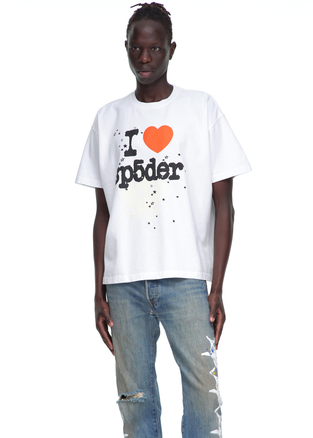 Male model in a white 14oz cotton Souvenir Tee with "I ❤️ Sp5der" graphic, paired with distressed jeans.