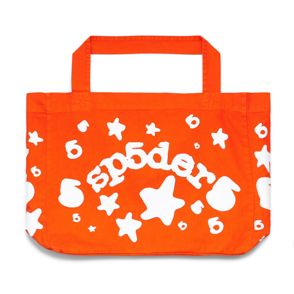 Orange 8oz twill tote bag with white "sp5der" puff print, stars, and "6" graphics.