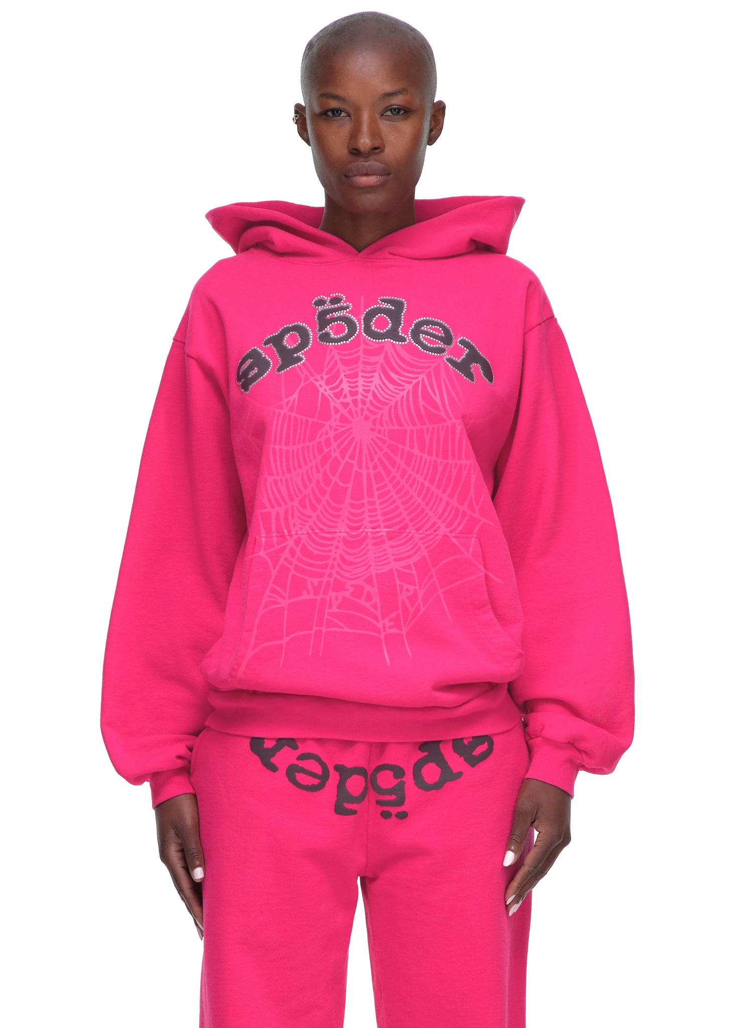 Pink LEGACY HOODIE and sweatpants with rhinestone SP5DER text and web print.