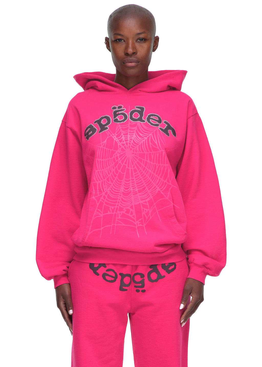 Pink LEGACY HOODIE and sweatpants with rhinestone SP5DER text and web print.