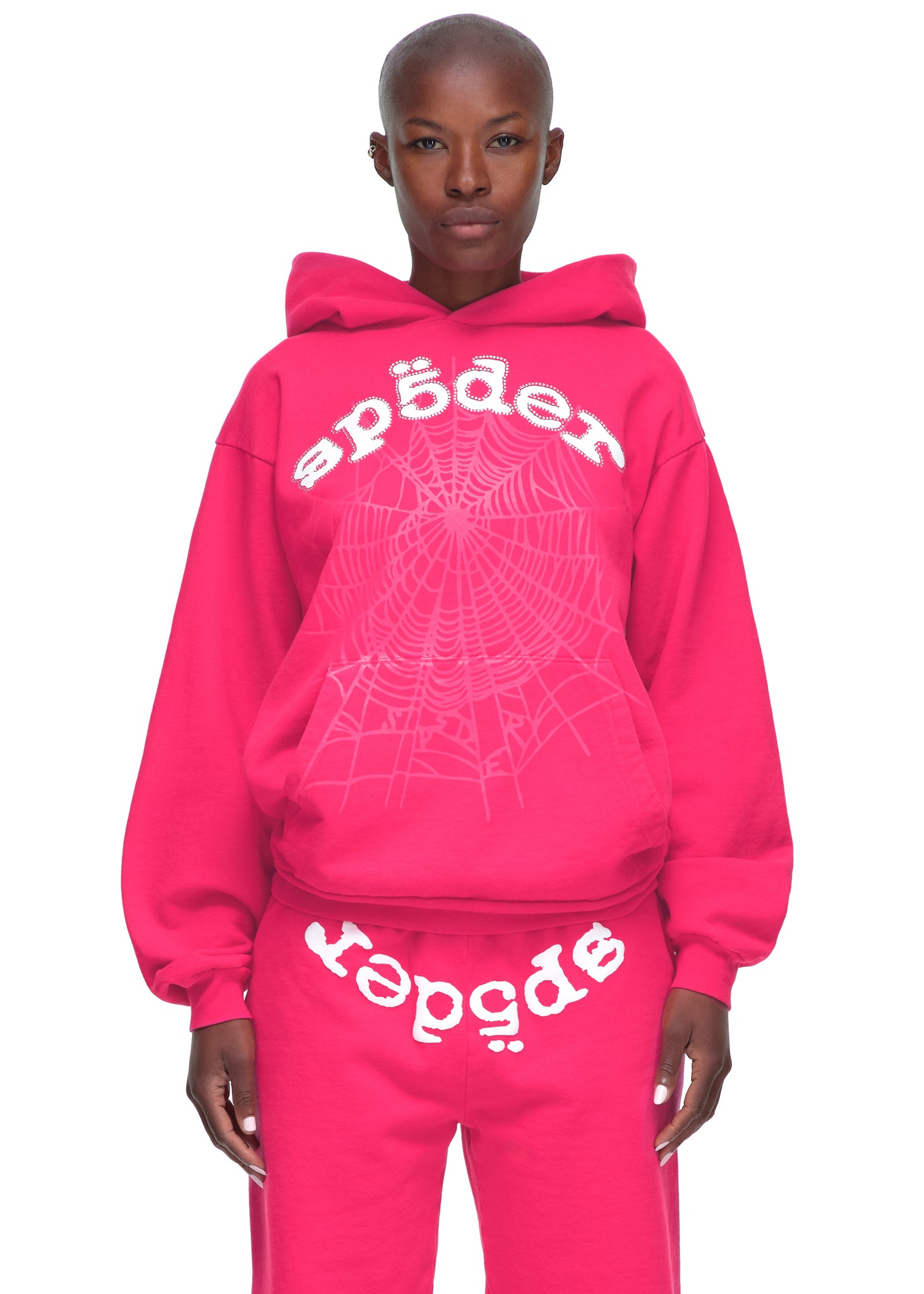 Pink LEGACY HOODIE with white puff print "sp5der" text, rhinestone web, and matching sweatpants.