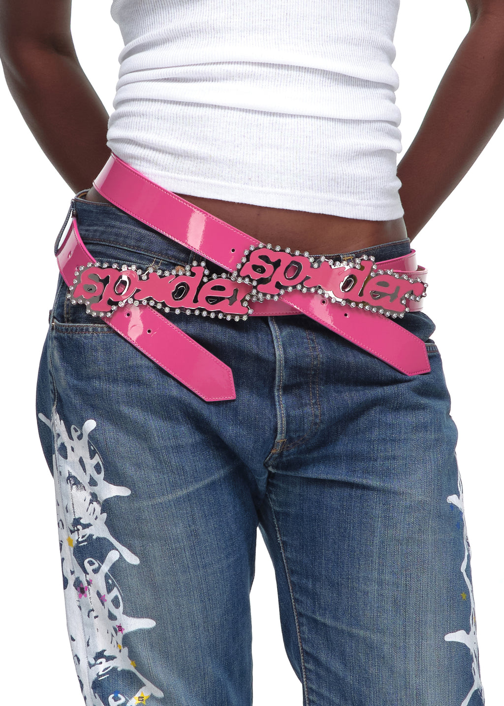 P*NK V2 BELT: Patent leather, rhinestone SP5DER buckle, worn with jeans.