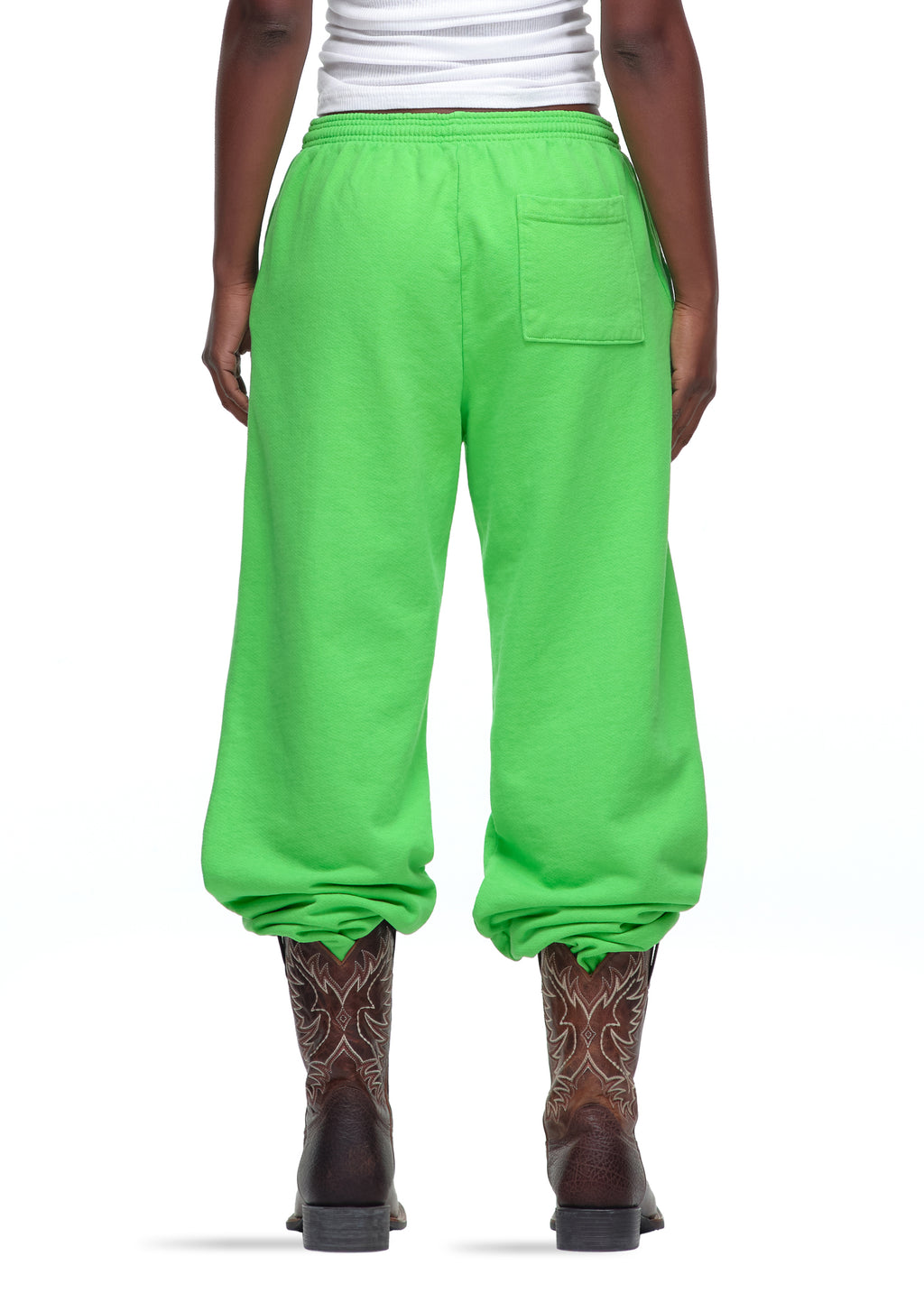 Lime green 23oz fleece sweatpants with elastic waist and cuffs, worn with cowboy boots.