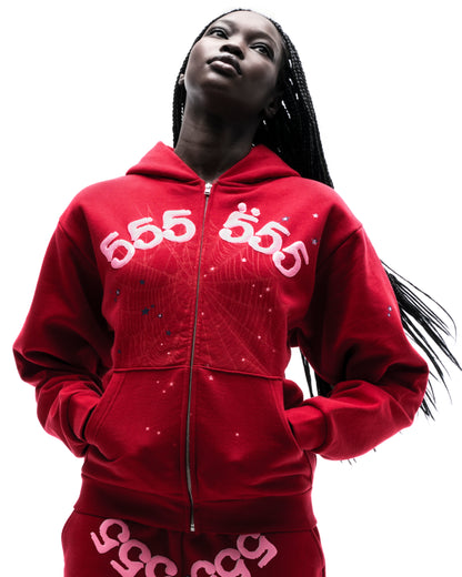 Model in red 100% cotton fleece zip hoodie with pink "555" angel number and scattered star puff print.