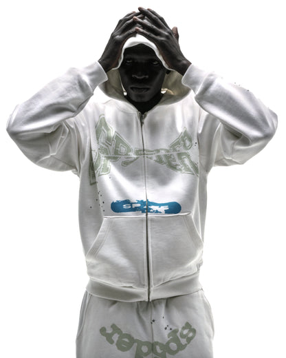 Model wearing a white 13oz cotton fleece T&F zip-up hoodie with puff/discharge print and scattered stars.