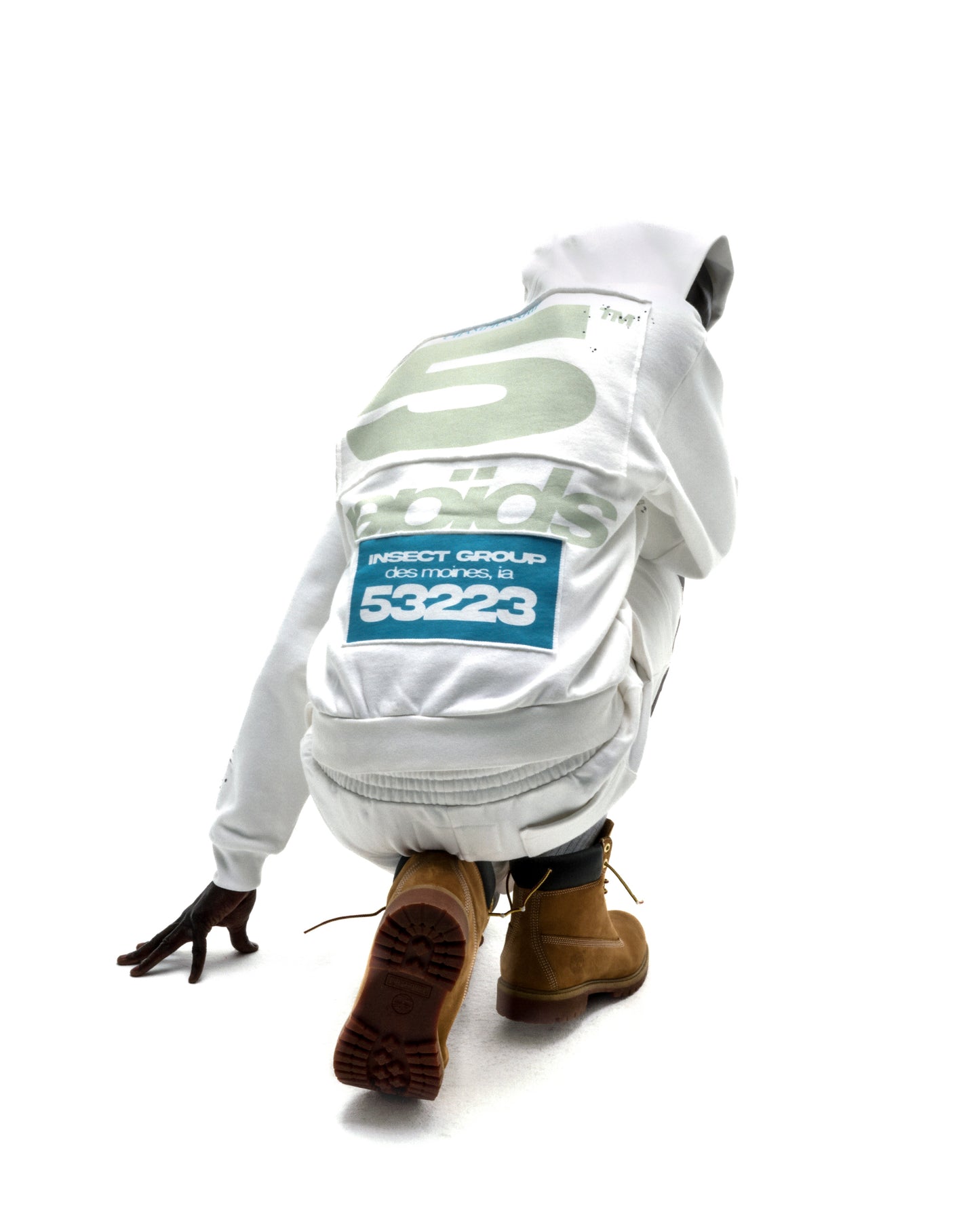 Model in white T&F zip-up hoodie with puff print, scattered stars, and "INSECT GROUP" text.