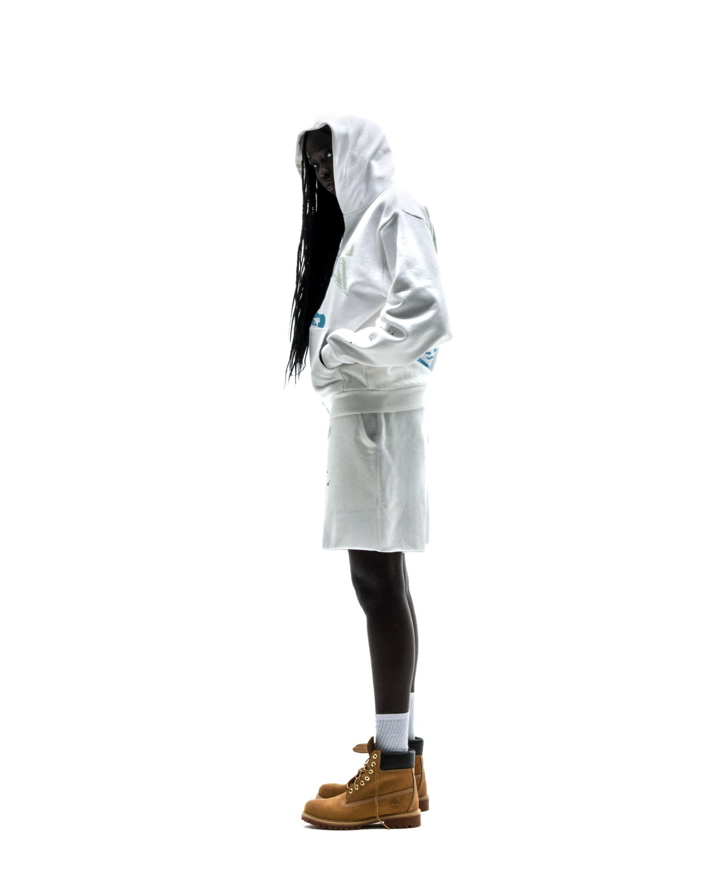 Model wearing a white T&F zip-up hoodie with scattered stars and matching shorts.