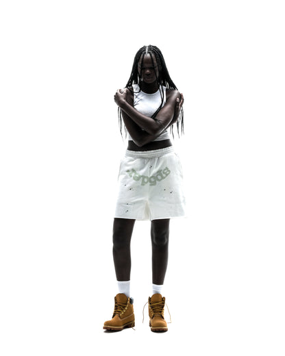 Model wearing white T&F SWEATSHORT with "SP5DER" text and star print, raw hem.