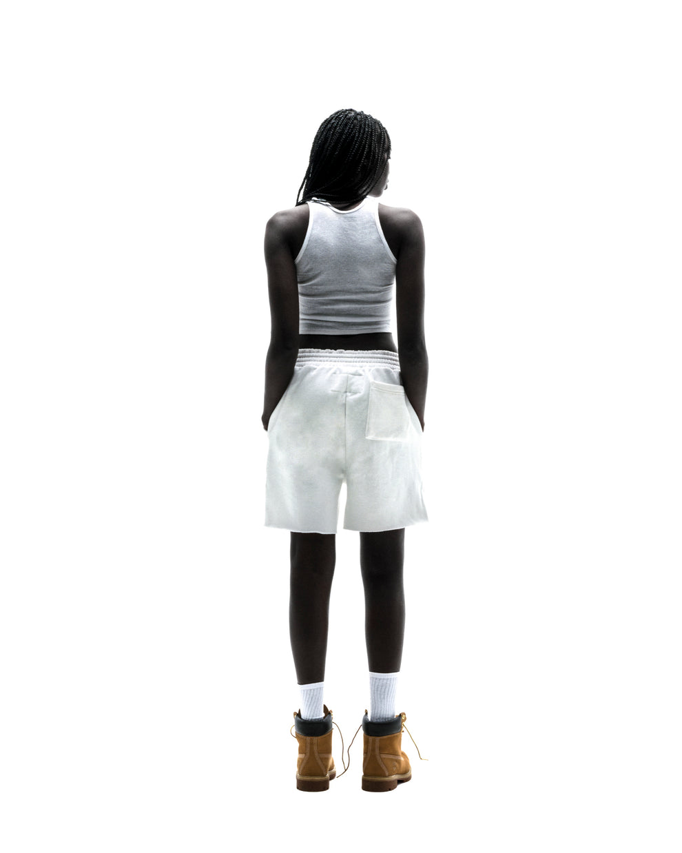 Model in white T&F SWEATSHORT, 13oz cotton fleece with back patch pocket and raw hem.
