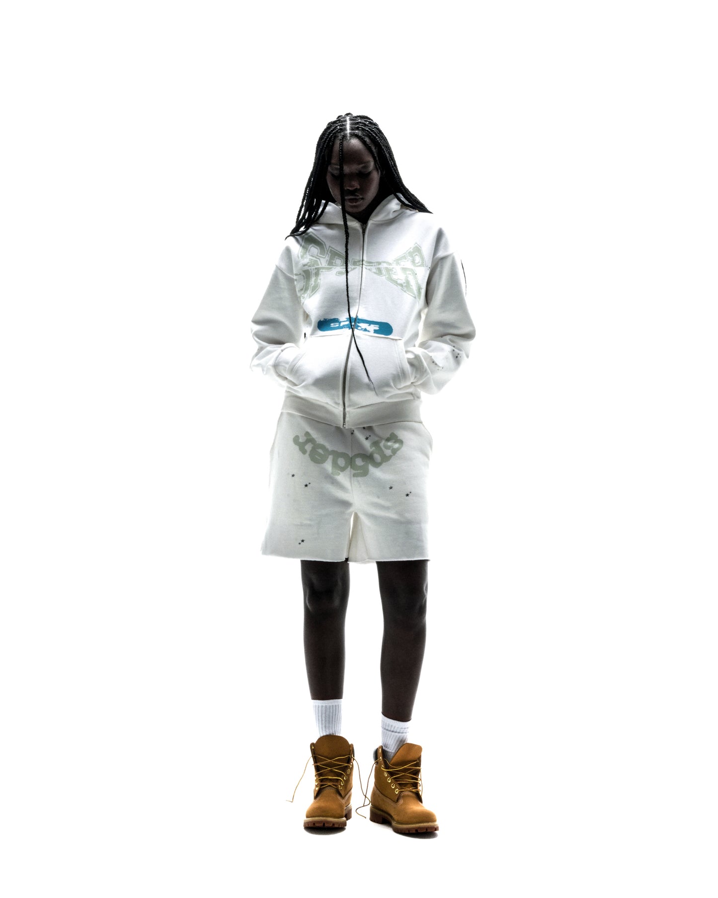 Model wearing a white 13oz cotton fleece T&F zip-up hoodie and matching shorts with scattered star print.
