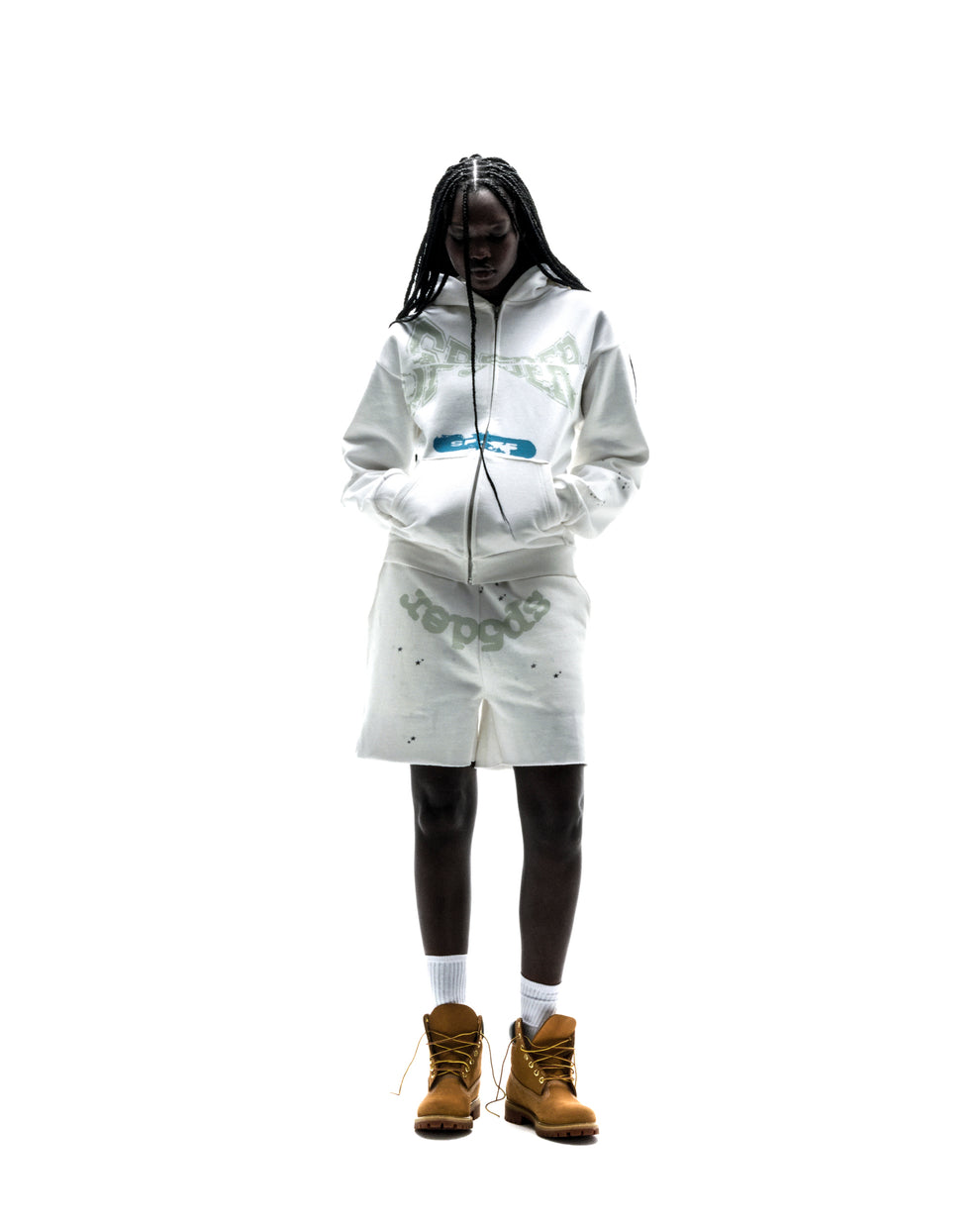 Model wearing a white 13oz cotton fleece T&F zip-up hoodie and matching shorts with scattered star print.