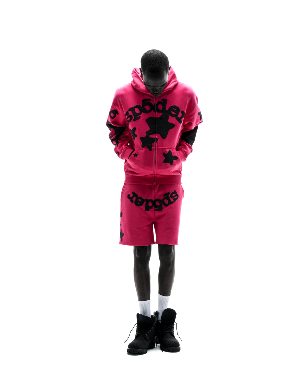 Model wearing a pink 13oz cotton fleece Beluga Zip Up hoodie and matching shorts with black puff print.