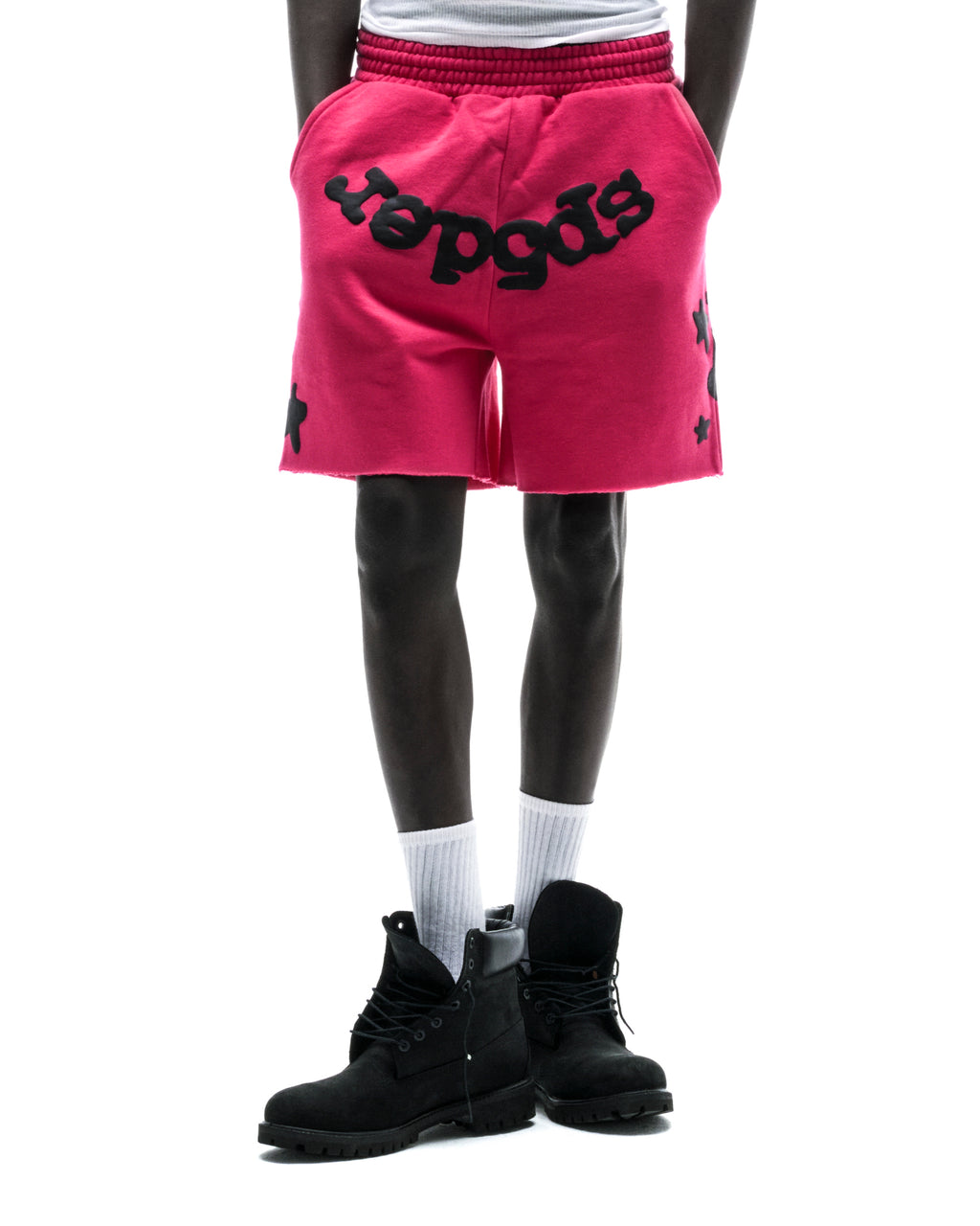 Model wearing pink Beluga sweatshorts with black "Beluga" print, raw hem, and black star details.