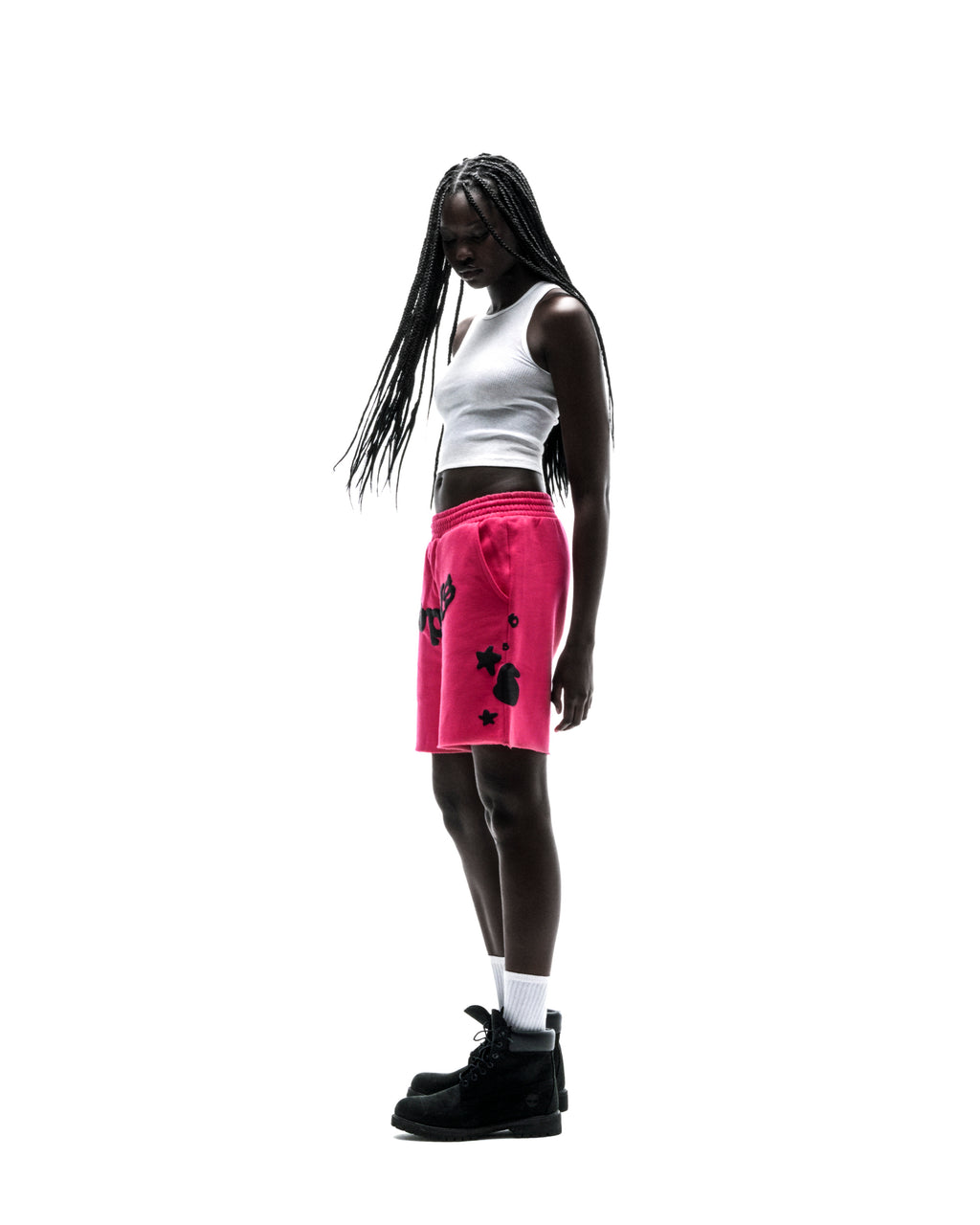 Model in pink Beluga sweatshorts with black print, drawcord, and raw hem.