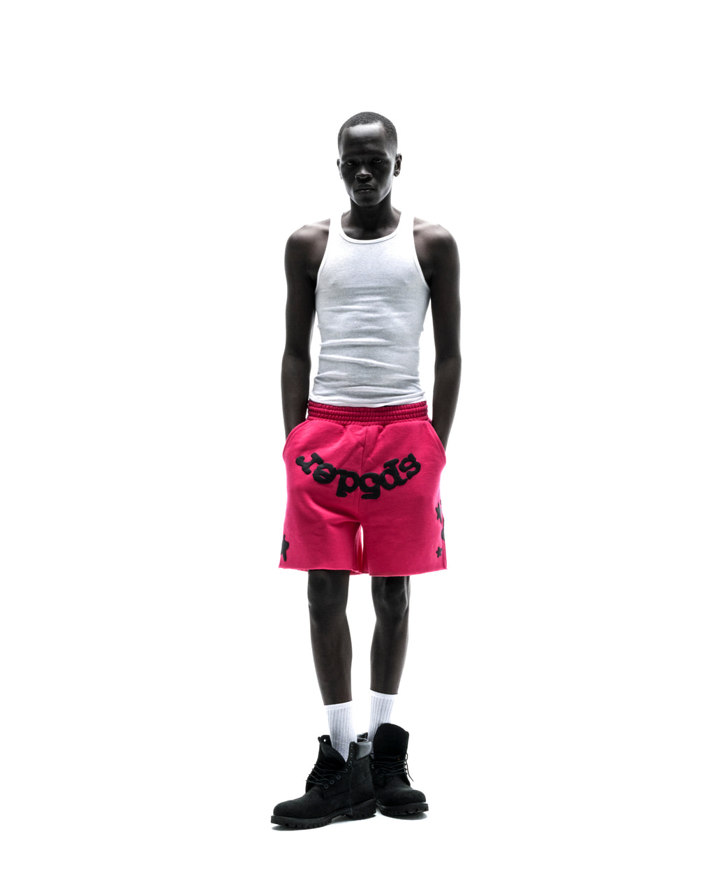 Model wears pink Beluga sweatshorts with black print, drawcord, and raw hem.