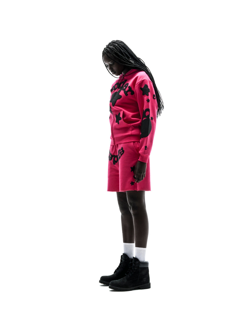 Model in a pink 13oz cotton fleece Beluga Zip Up hoodie and matching shorts with black puff print designs.