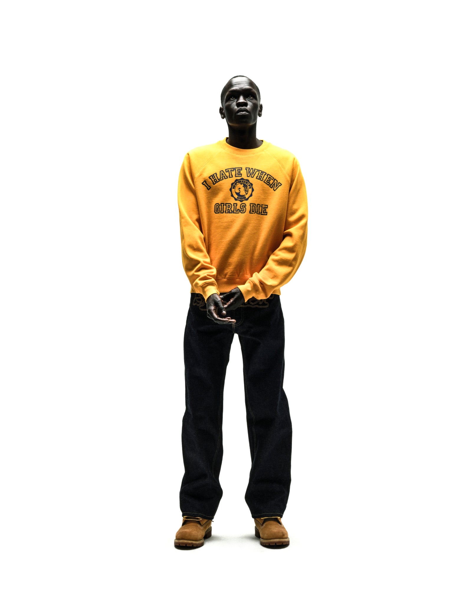 Yellow 100% cotton brushed fleece raglan crewneck with navy blue graphic print on front, ribbed collar, hem, and cuffs.