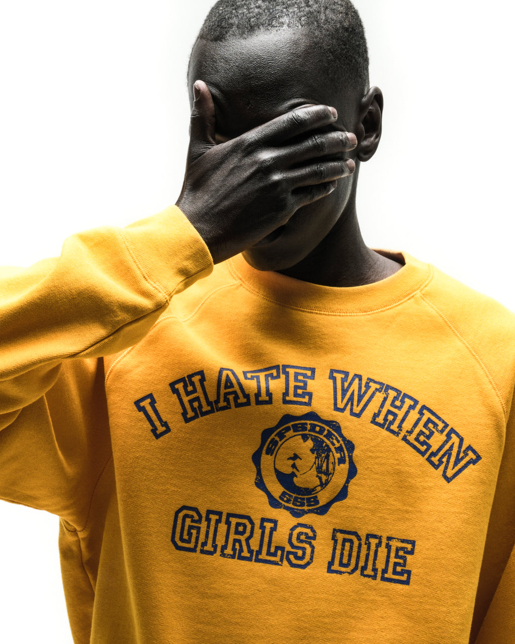 Yellow 100% cotton raglan crewneck featuring a blue graphic print on the chest with ribbed collar and cuffs.