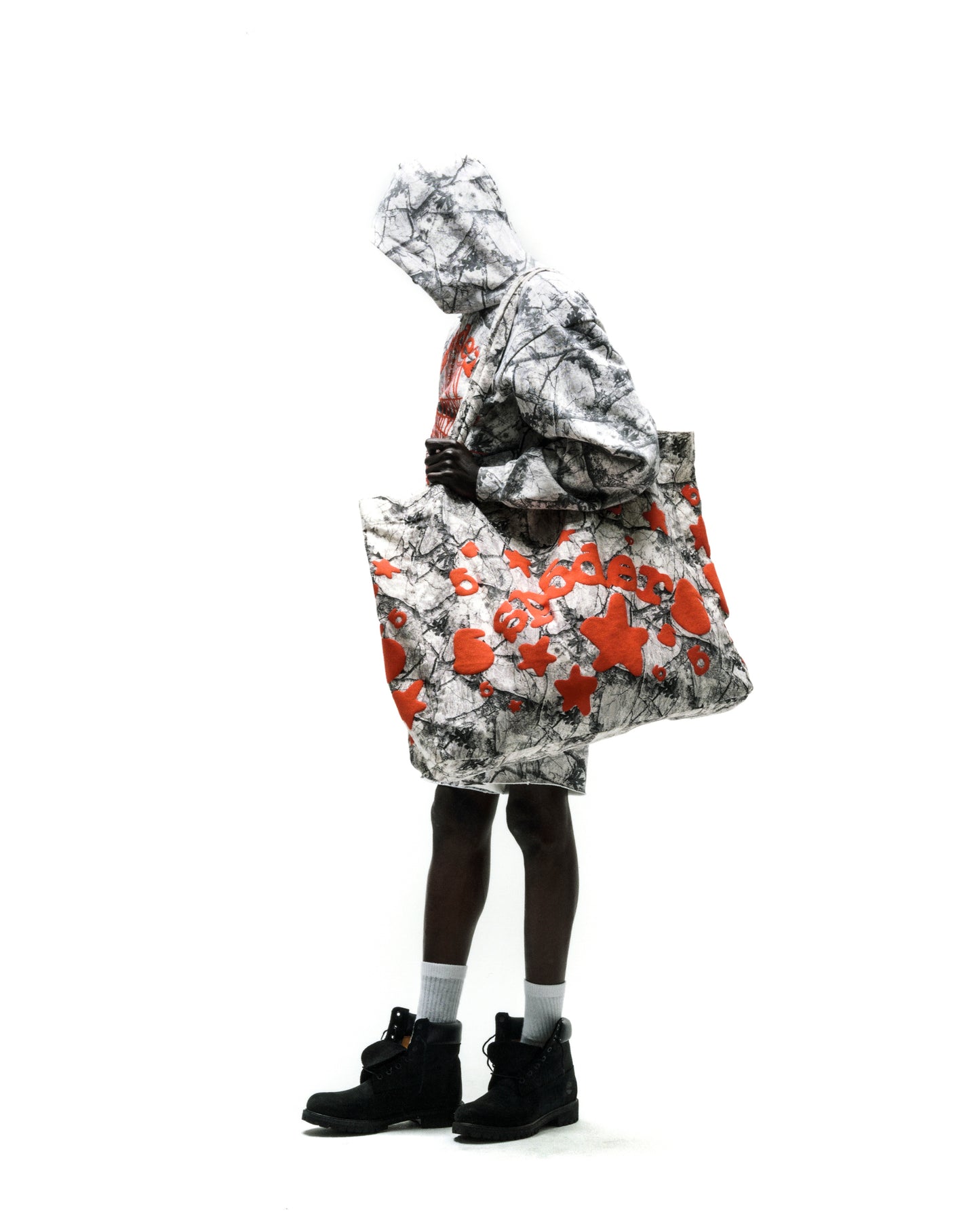 REALTREE BELUGA TOTE BAG, 8oz brushed twill with red beluga graphic print, held by a model.