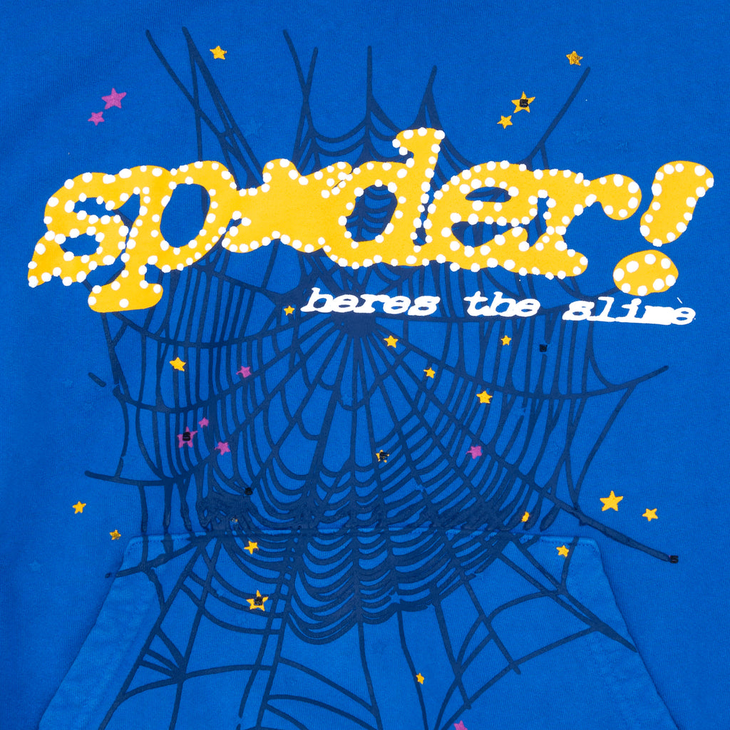 TC BLUE HOODIE with yellow "SP5DER!" puff print, spider web, stars, and "heres the slime" text.