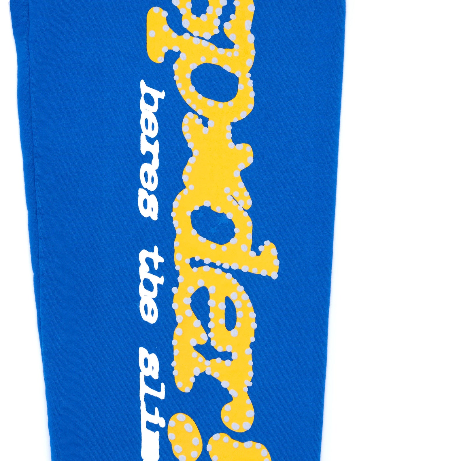 TC BLUE sweatpant with yellow puff print "SP5DER!" text and star design down the leg.
