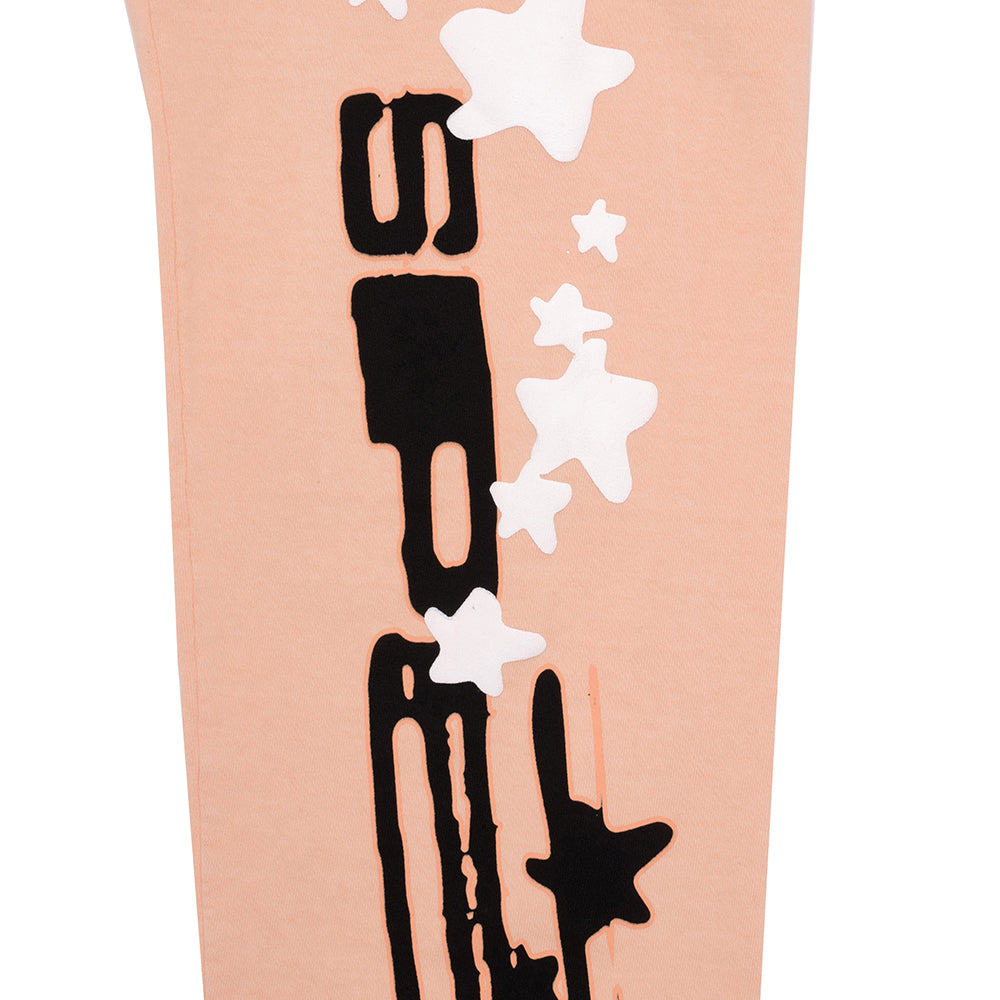 Bellini SP5 sweatpant, close-up of peach 23oz fleece with black SP5 text and white star puff prints.