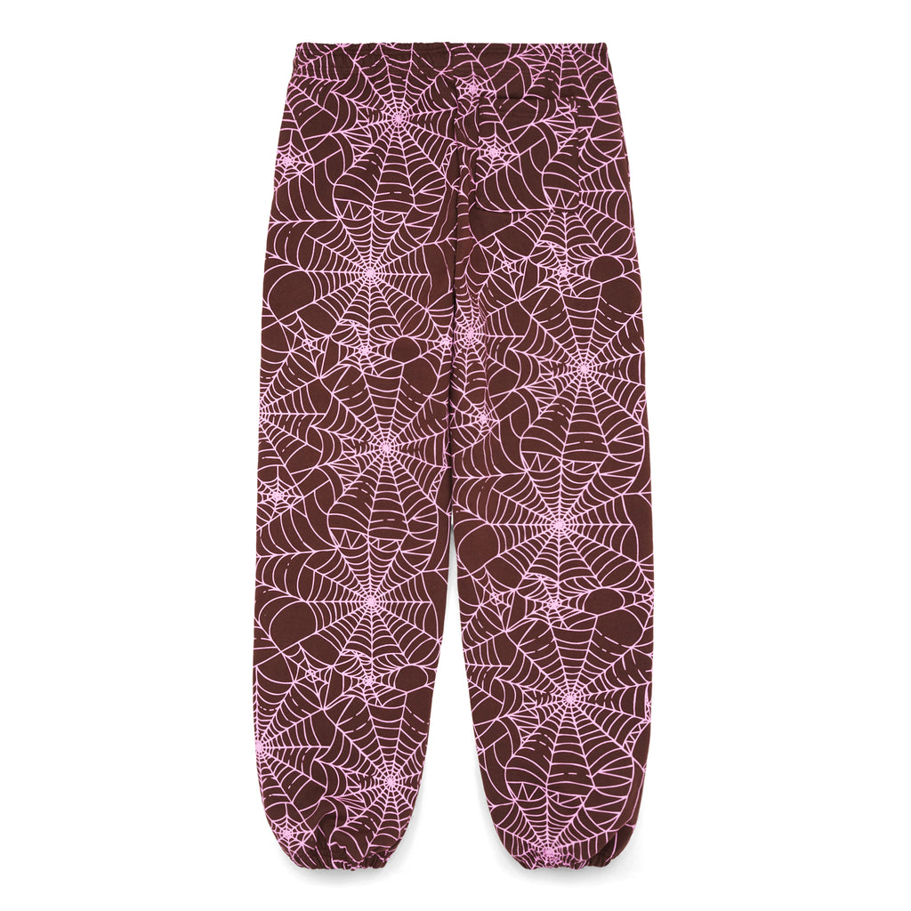 Brown fleece sweatpants with all-over pink cracked spider web print and small 'SP5DER' text.