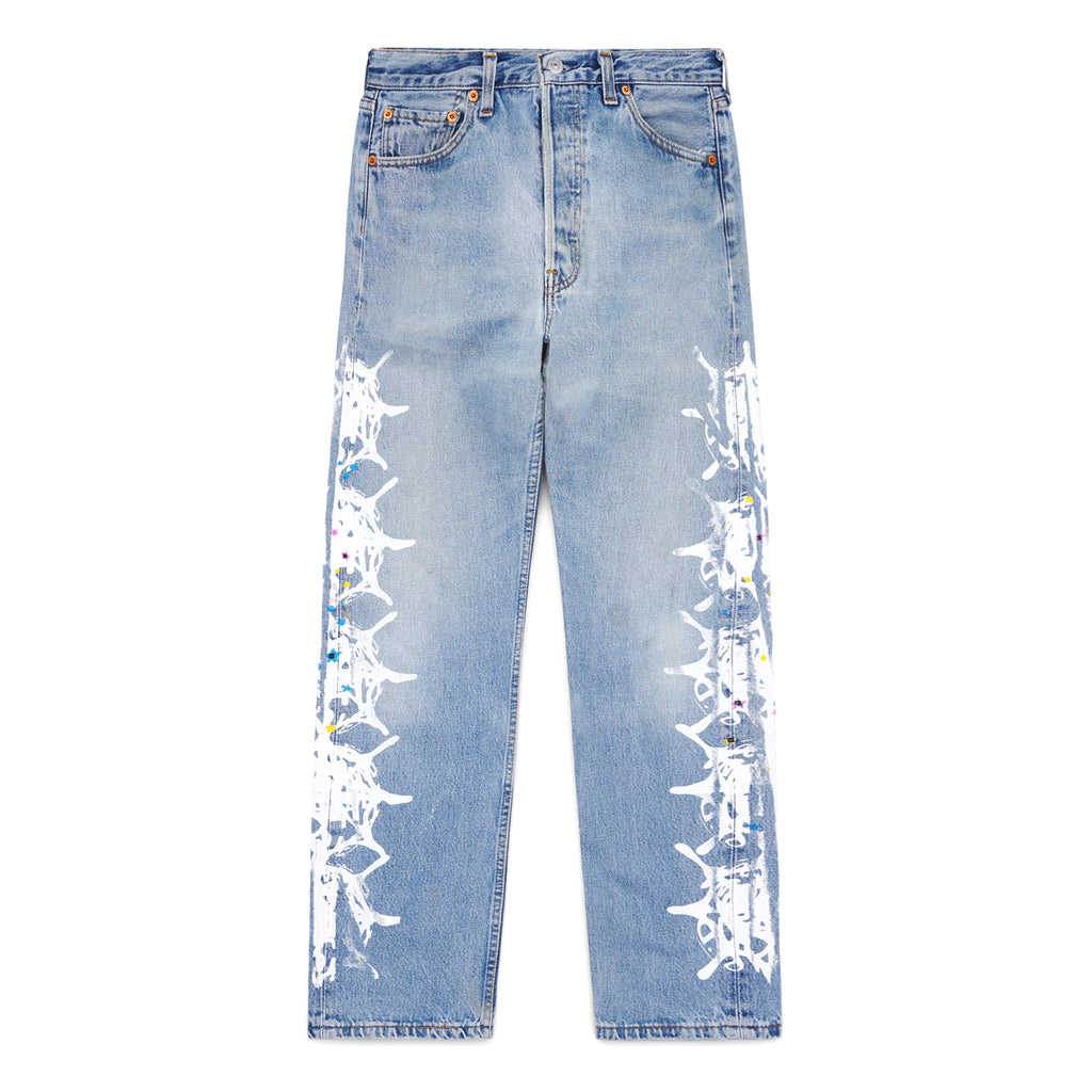 Vintage Levi's 501 light wash denim jeans with white contrast web design and colorful paint splatters down the legs.