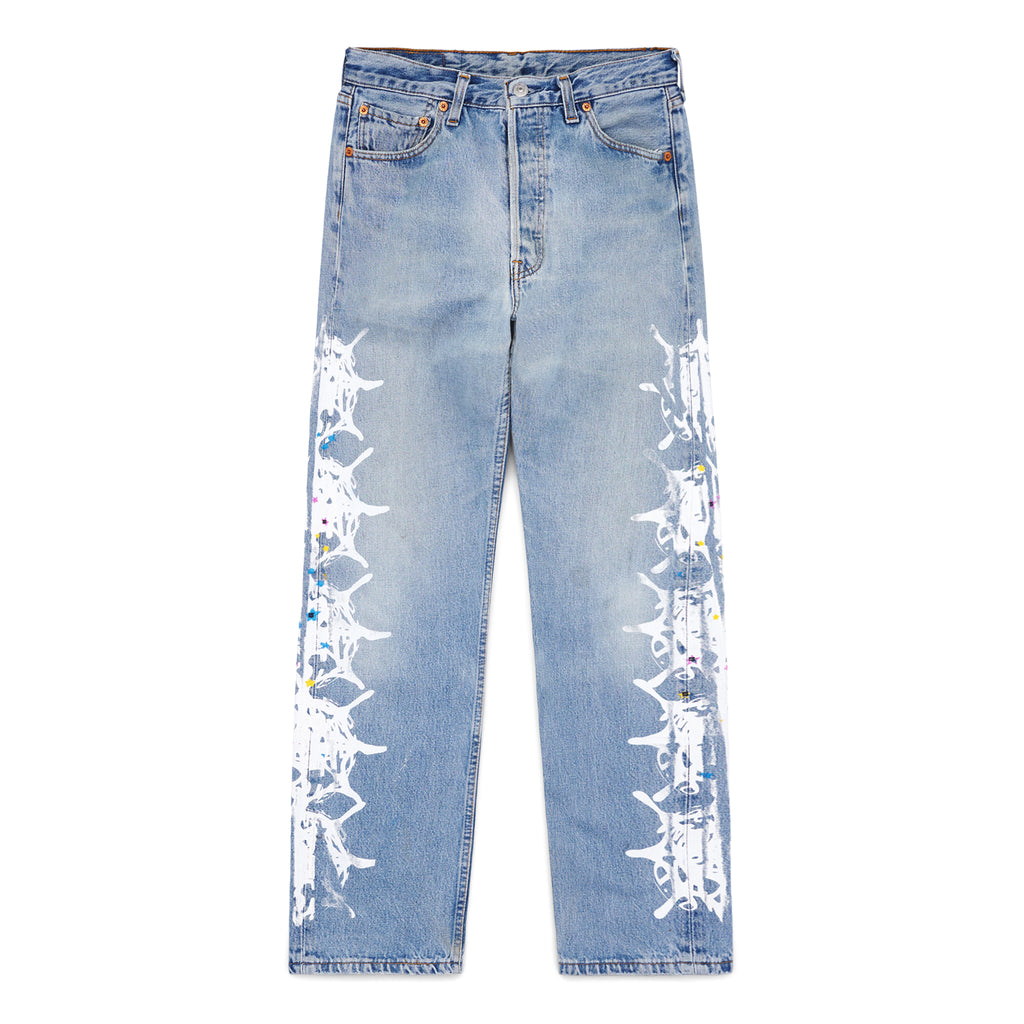 Vintage Levi's 501 denim jeans with white contrast web design down each leg, featuring colorful paint splatters.