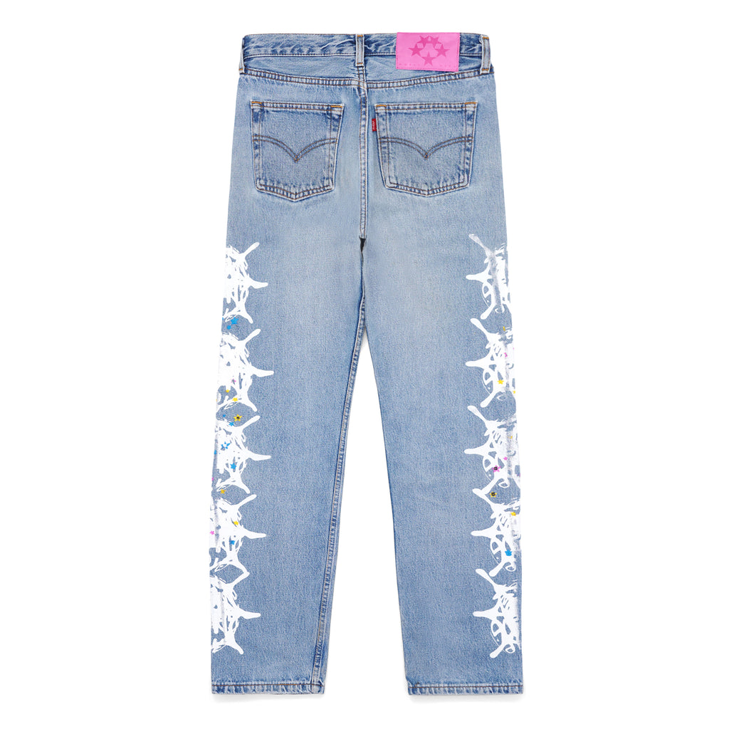Vintage Levi's 501 denim jeans with a pink leather SP5DER back tab and white contrast web design down each leg.