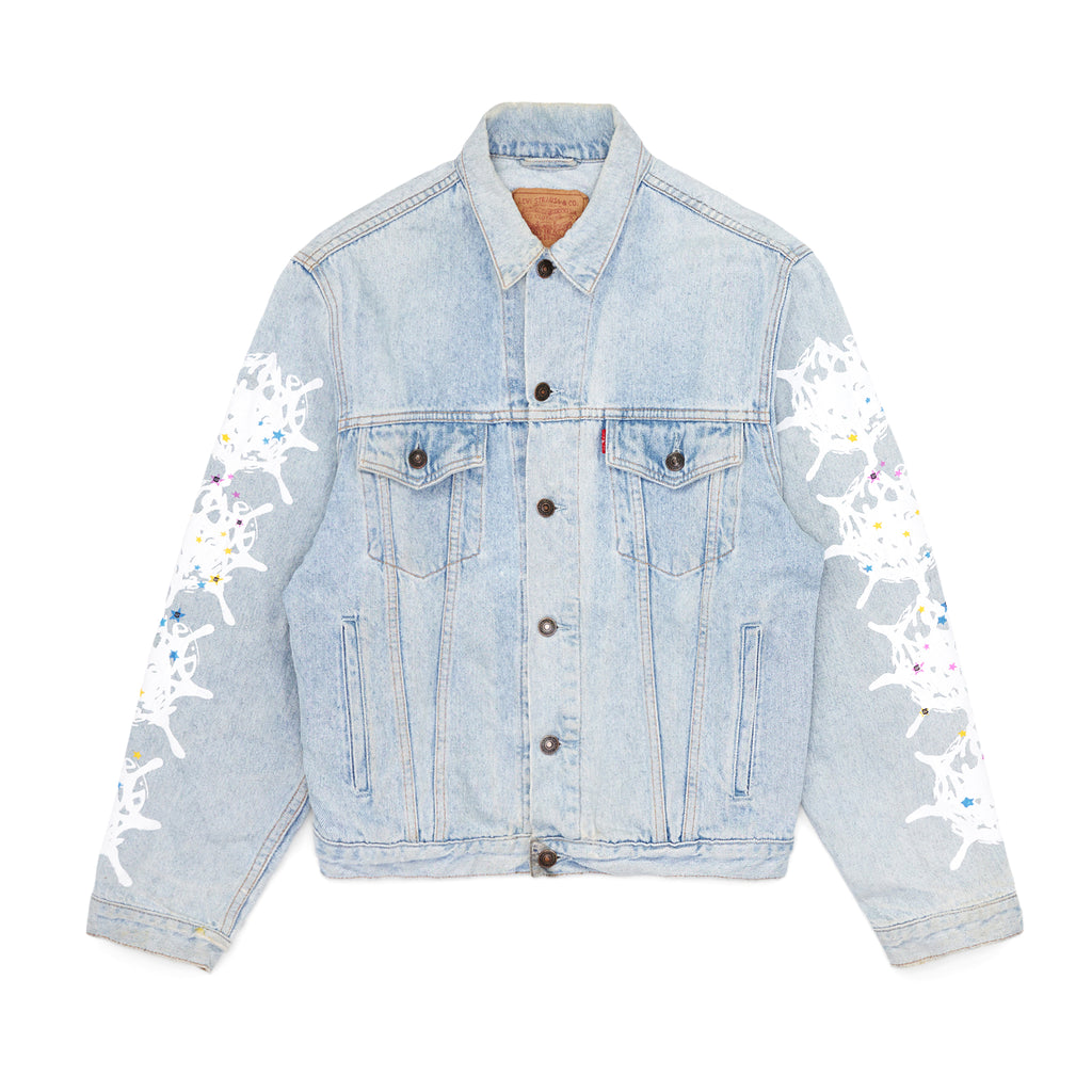 Light wash vintage Levi's denim trucker jacket with white contrast web and colorful stars on sleeves.
