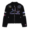 Black sherpa moto jacket with "HUNTERS" graphic, SP5DER patches, zip closure, and welt pockets.