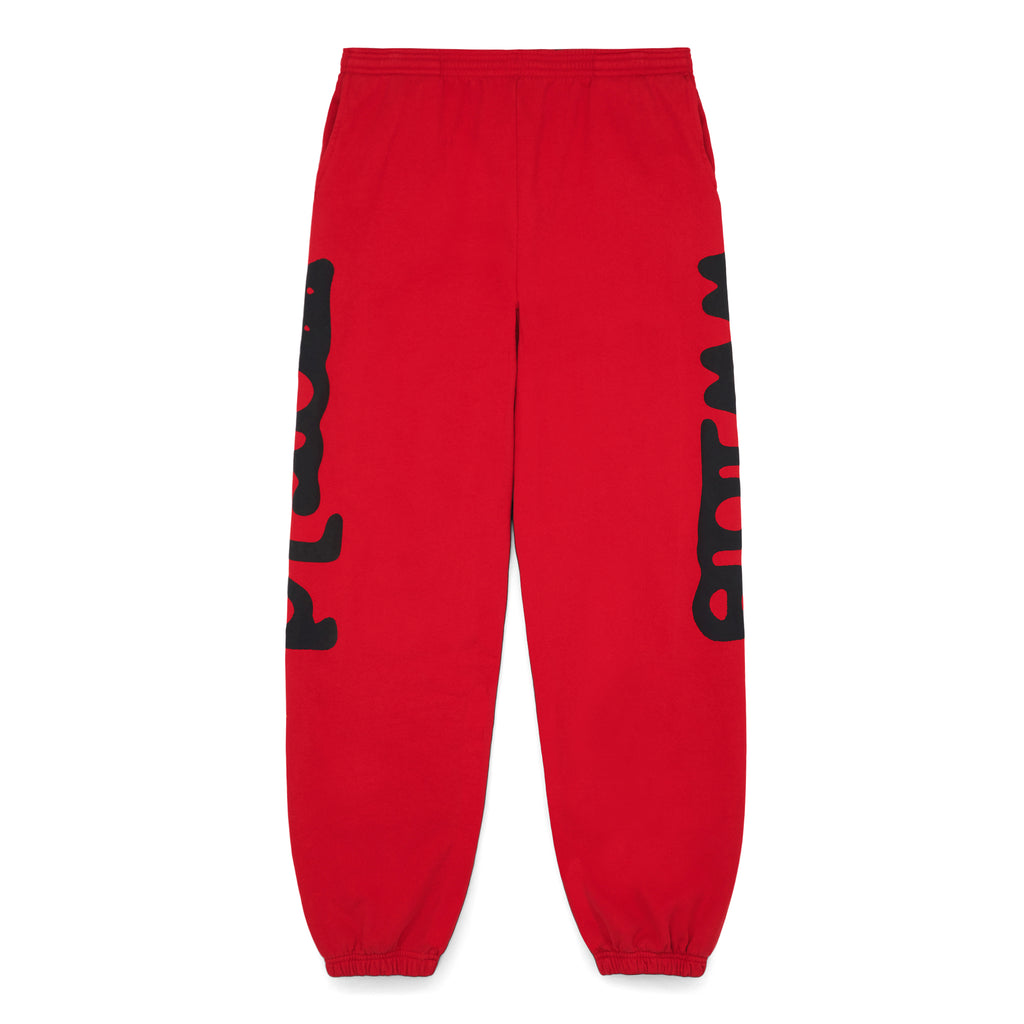 Red Beluga sweatpants with black 'Worldwide' puff and discharge print down both legs.