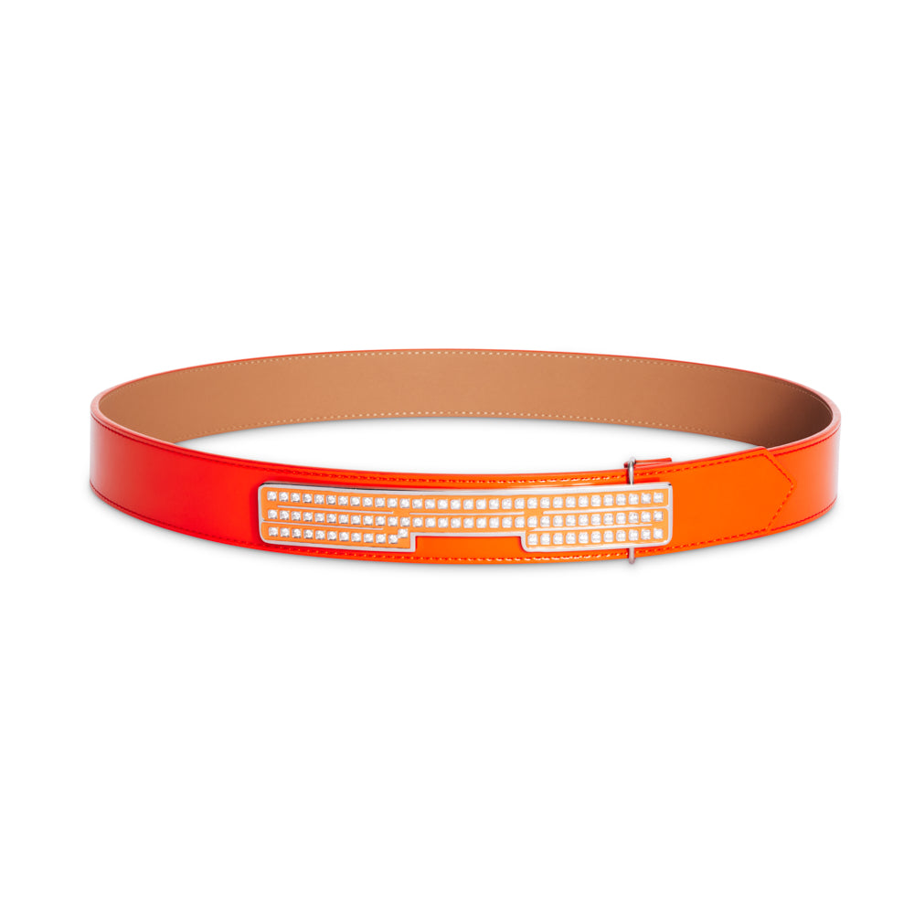 Orange and red leather belt with a rectangular rhinestone-encrusted SP5 logo buckle.