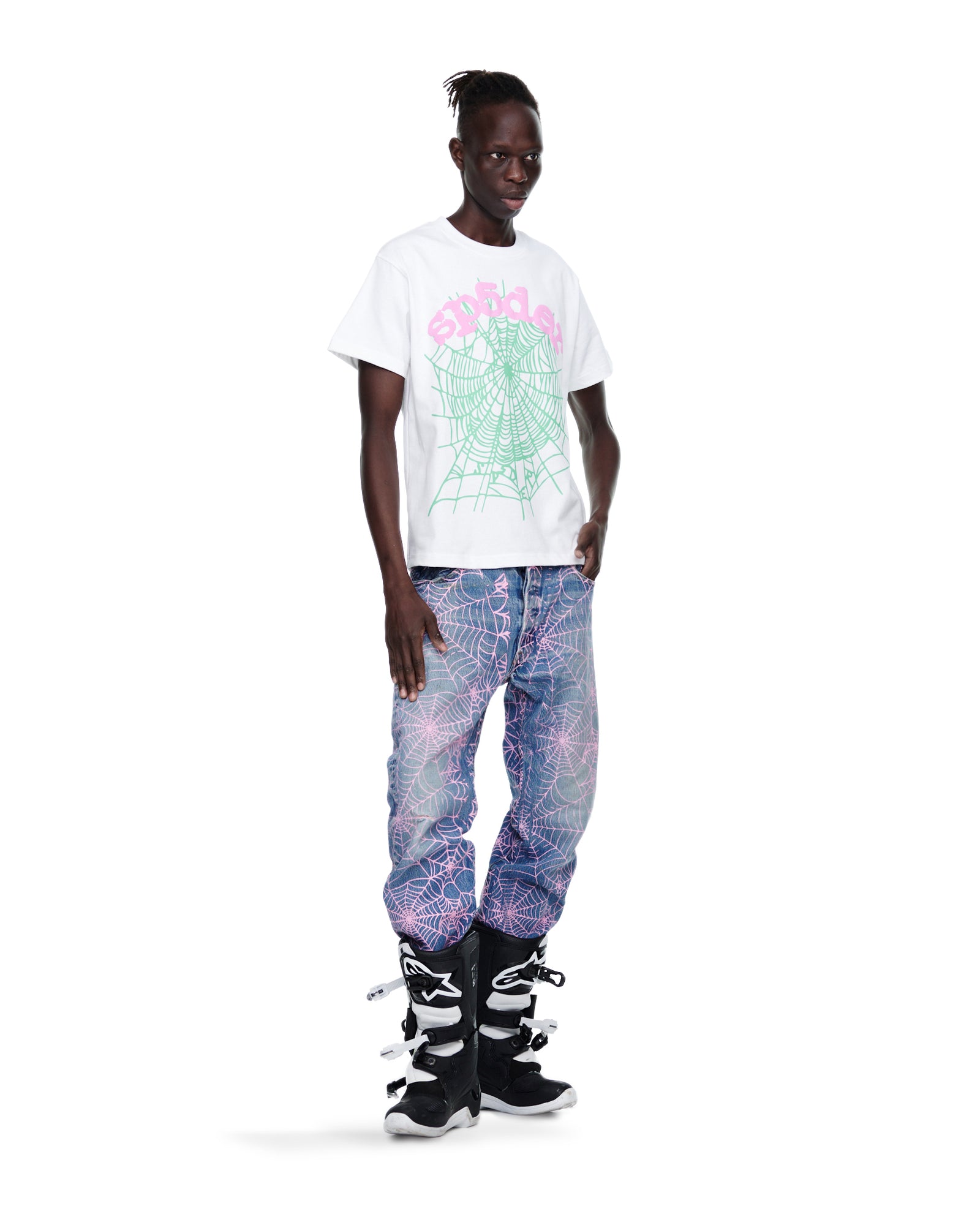 Male model in white tee with pink web print, vintage Levi's 501 denim with pink web, and black boots.