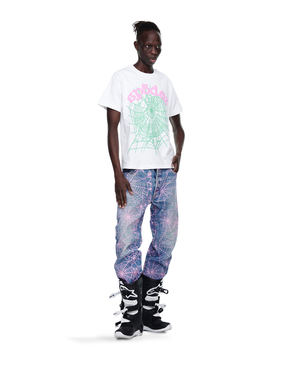 Male model in white tee with pink web print, vintage Levi's 501 denim with pink web, and black boots.