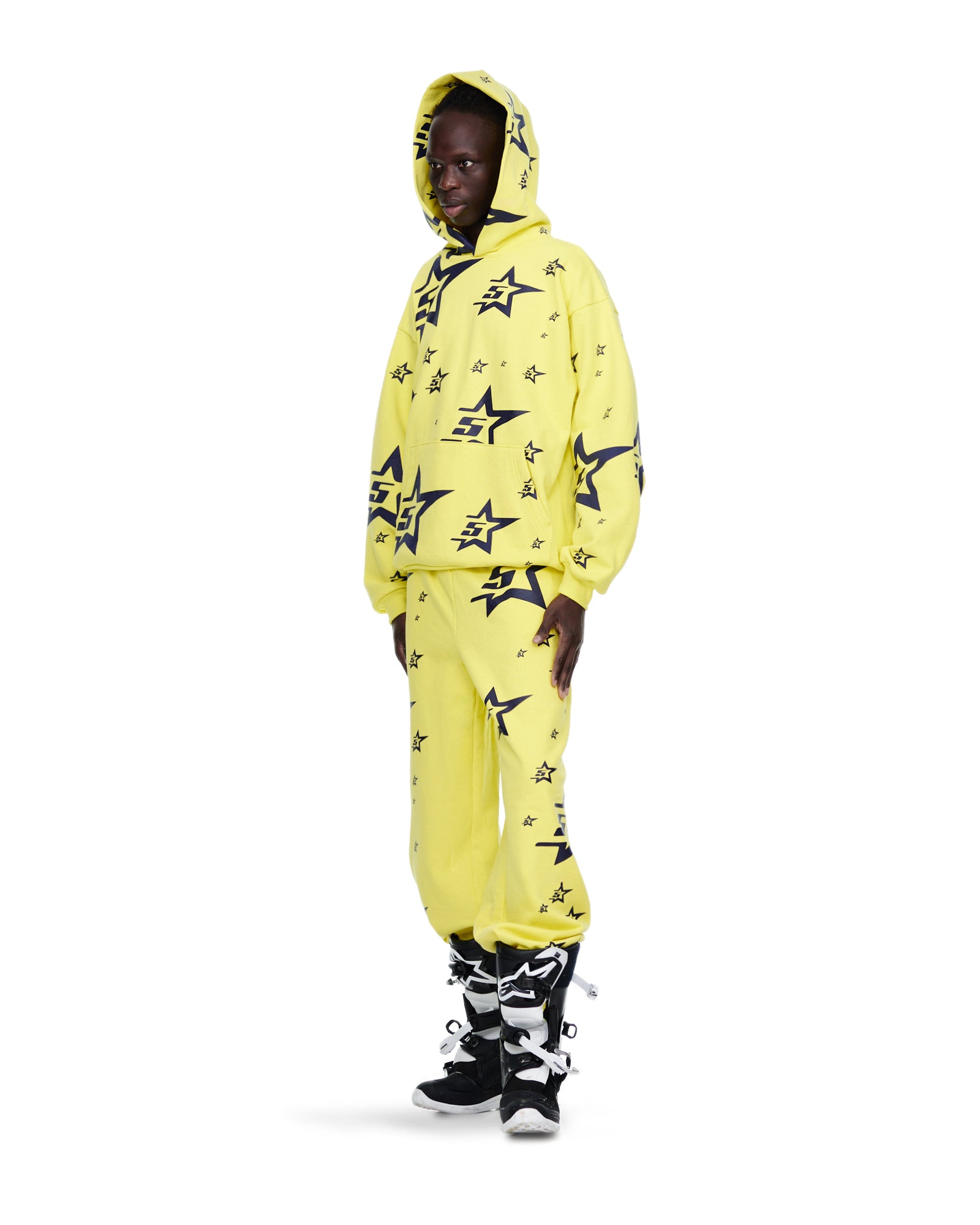 Man in yellow 23oz fleece sweatsuit with all-over screen-printed 5star and star design.