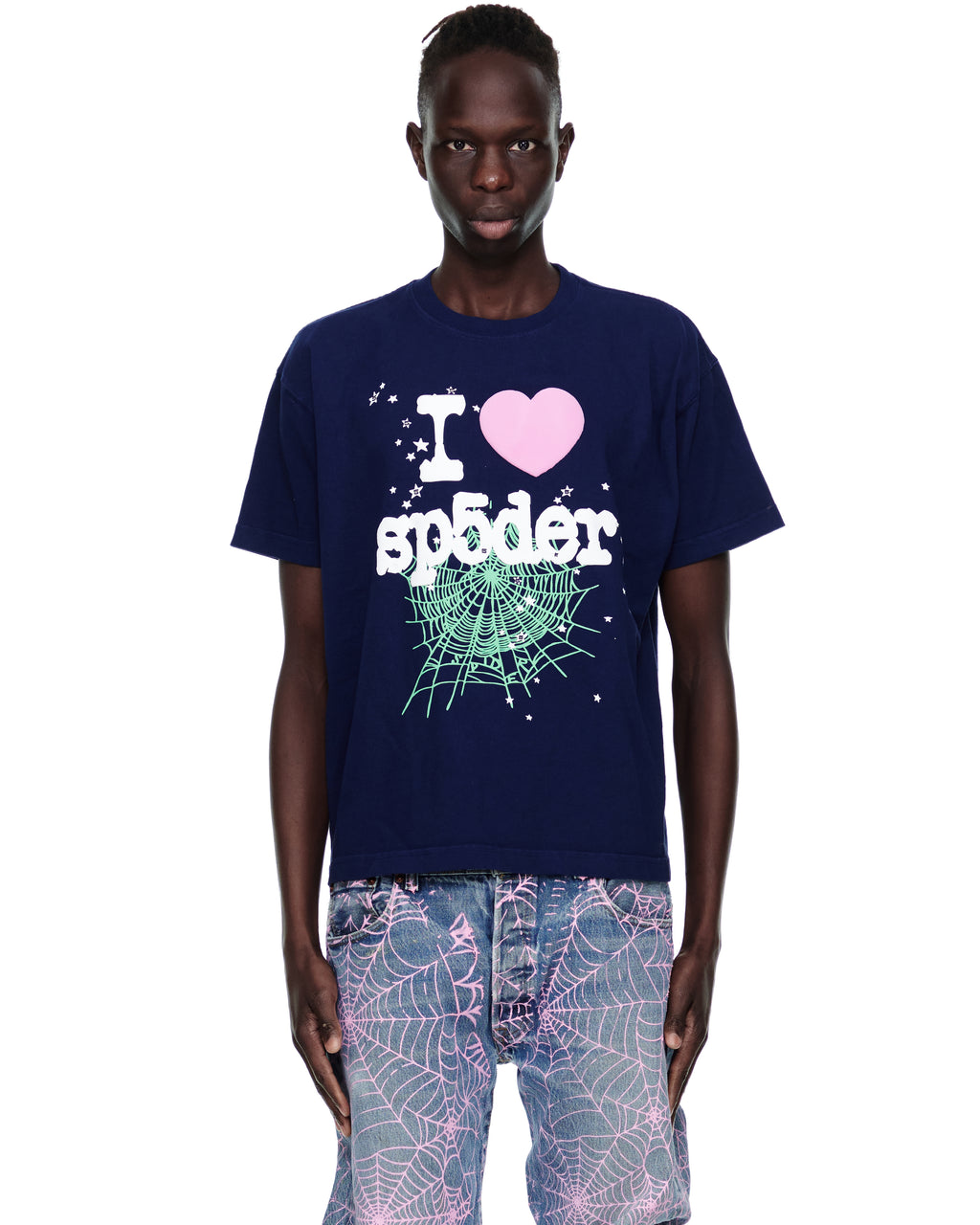 Male model in navy cotton SOUVENIR TEE with "I ❤️ sp5der" graphic, spiderweb, and stars.