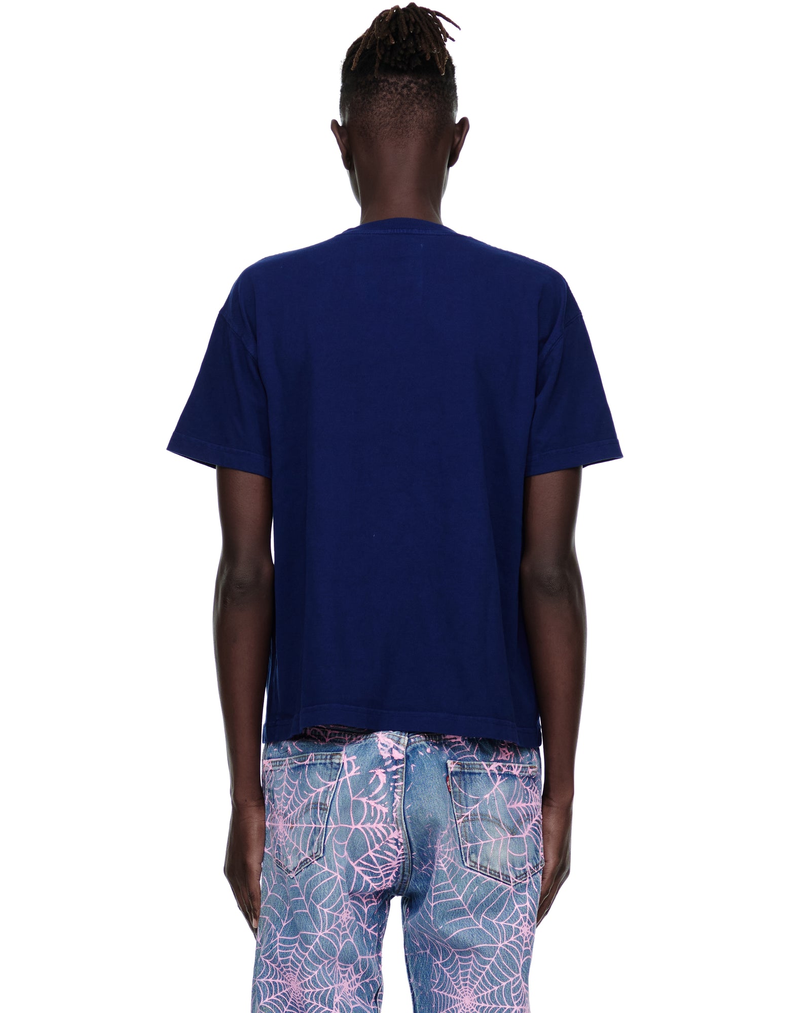 Back view of male model in a dark blue standard fit 14oz cotton Souvenir Tee.