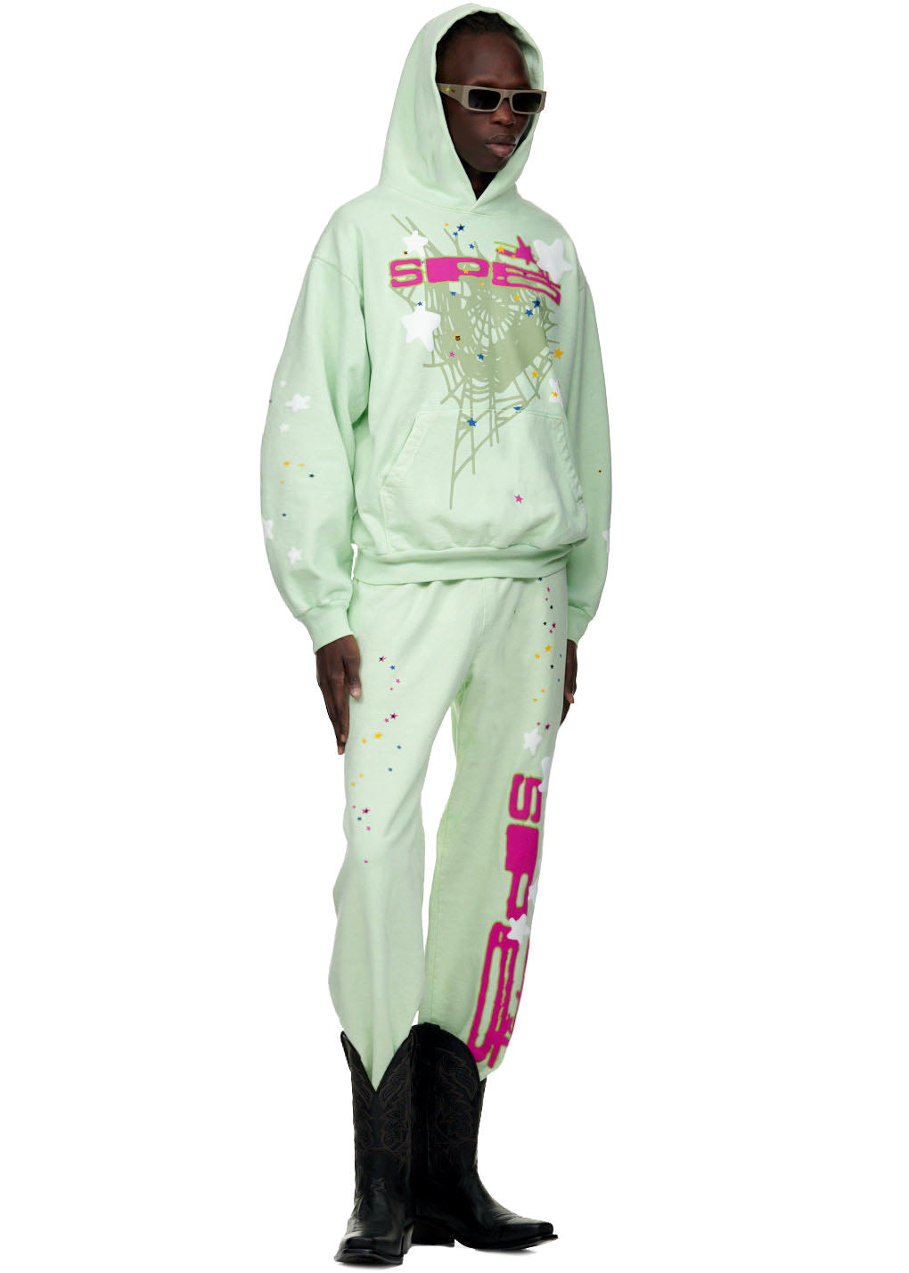 Mint green SP5 sweatpant and hoodie set with pink puff print, spiderweb, and star designs.
