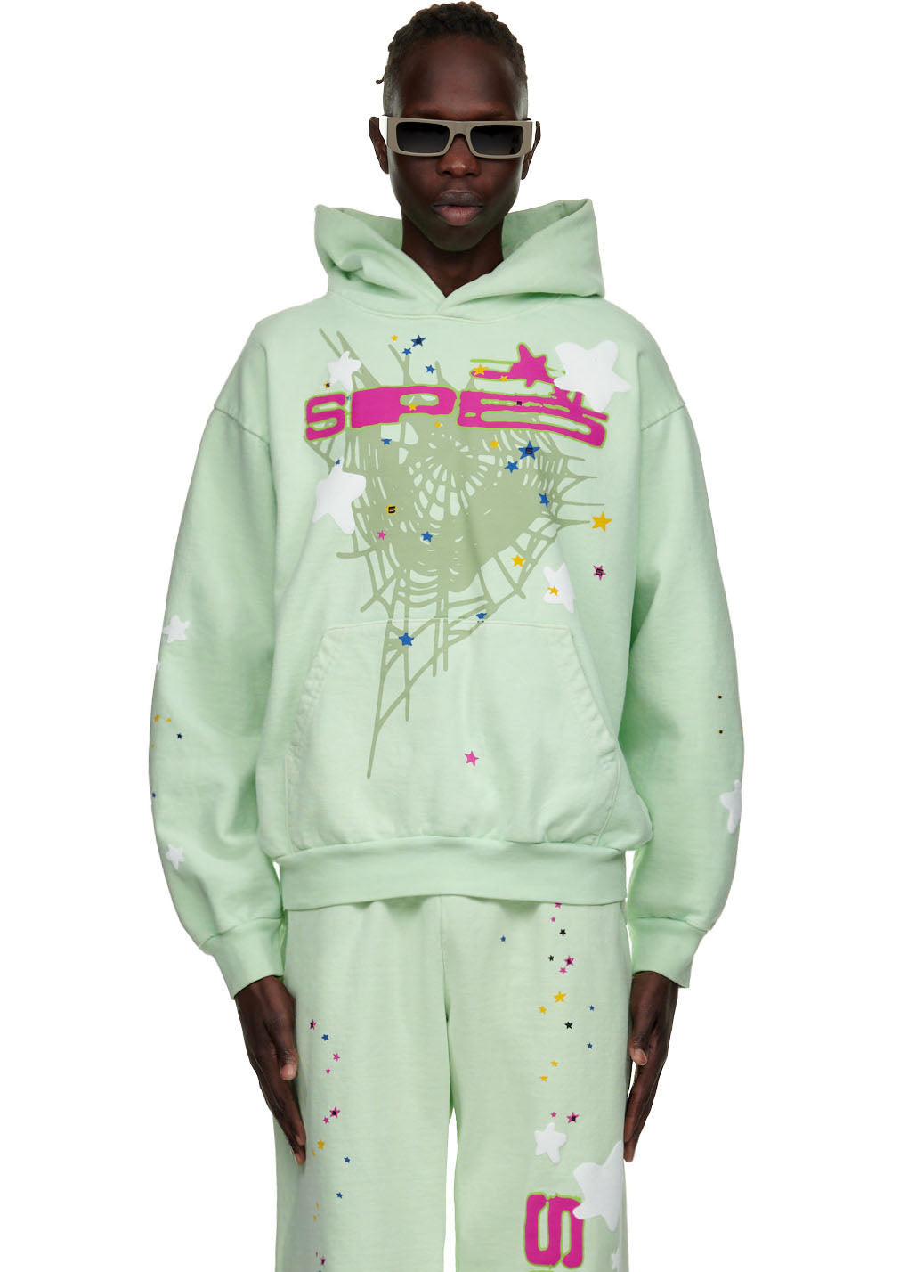 Mint green fleece hoodie with "SP5" puff print, web, and star graphics on front.