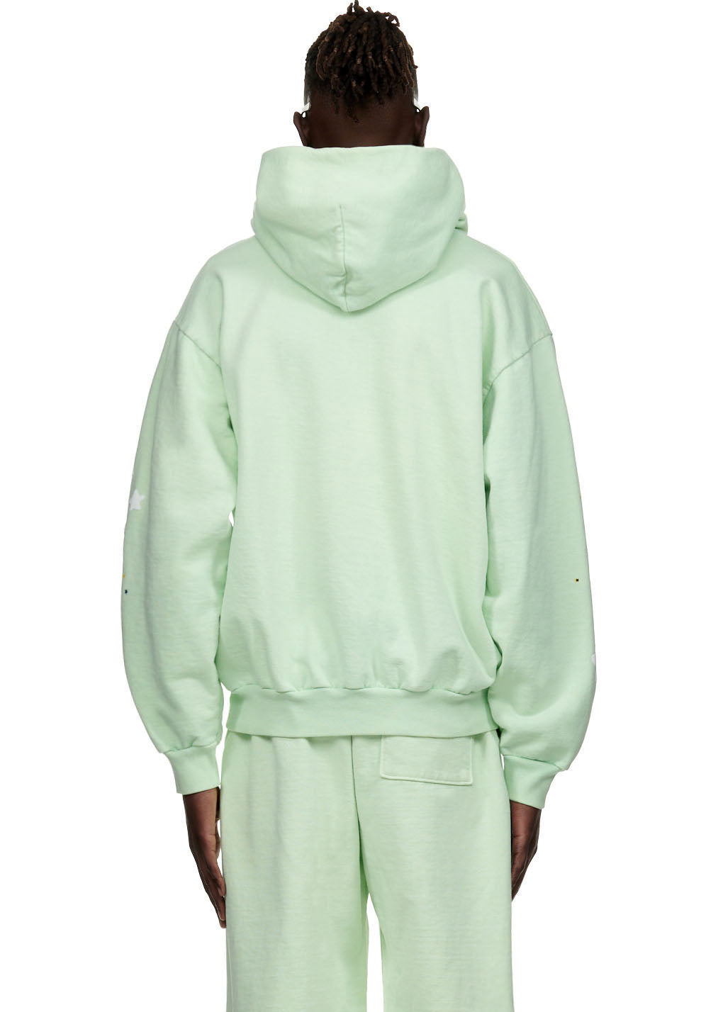 Back view of a mint green SP5 hoodie and matching sweatpants, featuring puff print stars on sleeves.