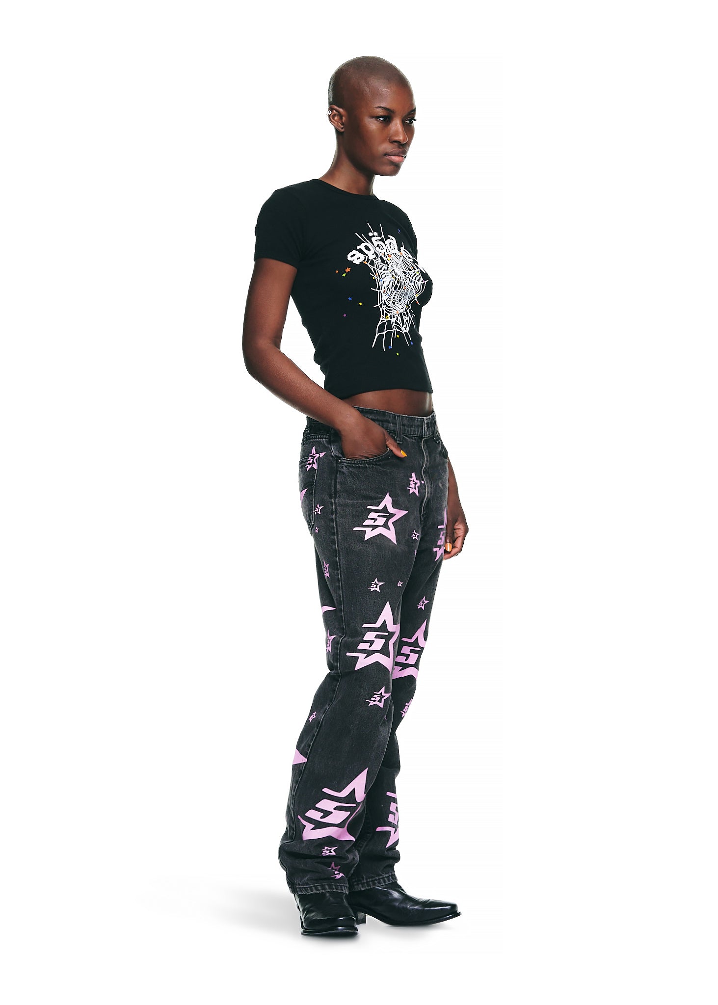 Female model in black OG WEB V2 BABY TEE with graphic print, cropped fit, and black jeans.