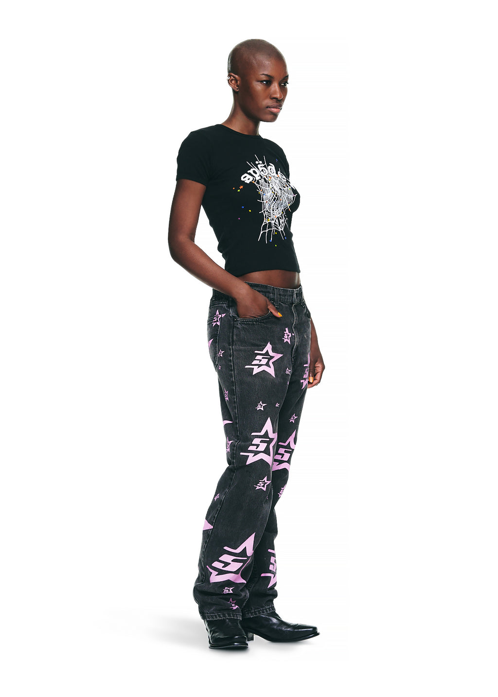 Female model in black OG WEB V2 BABY TEE with graphic print, cropped fit, and black jeans.