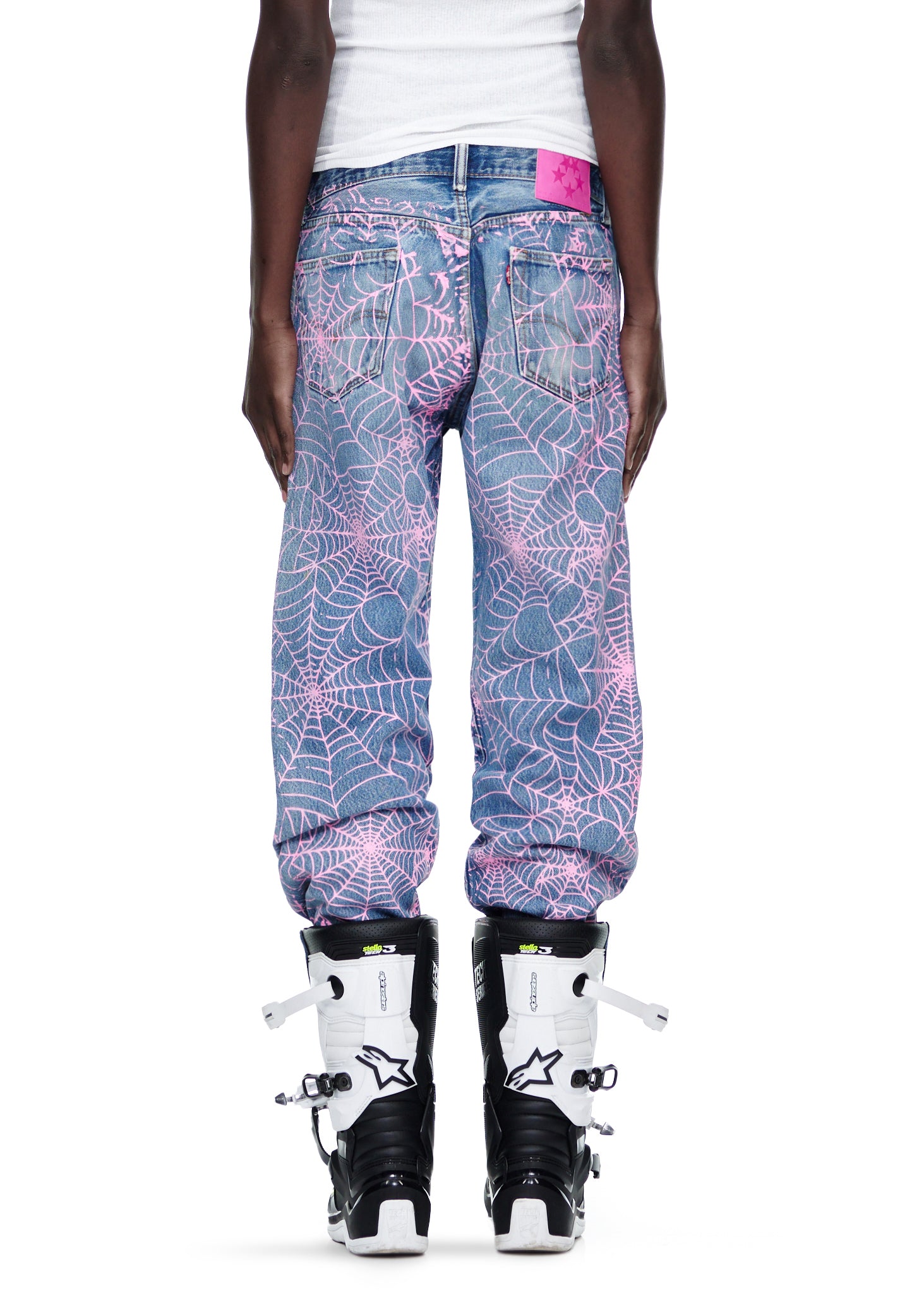 Vintage Levi's 501 denim jeans with all-over pink spiderweb print and a pink SP5DER leather back tab.